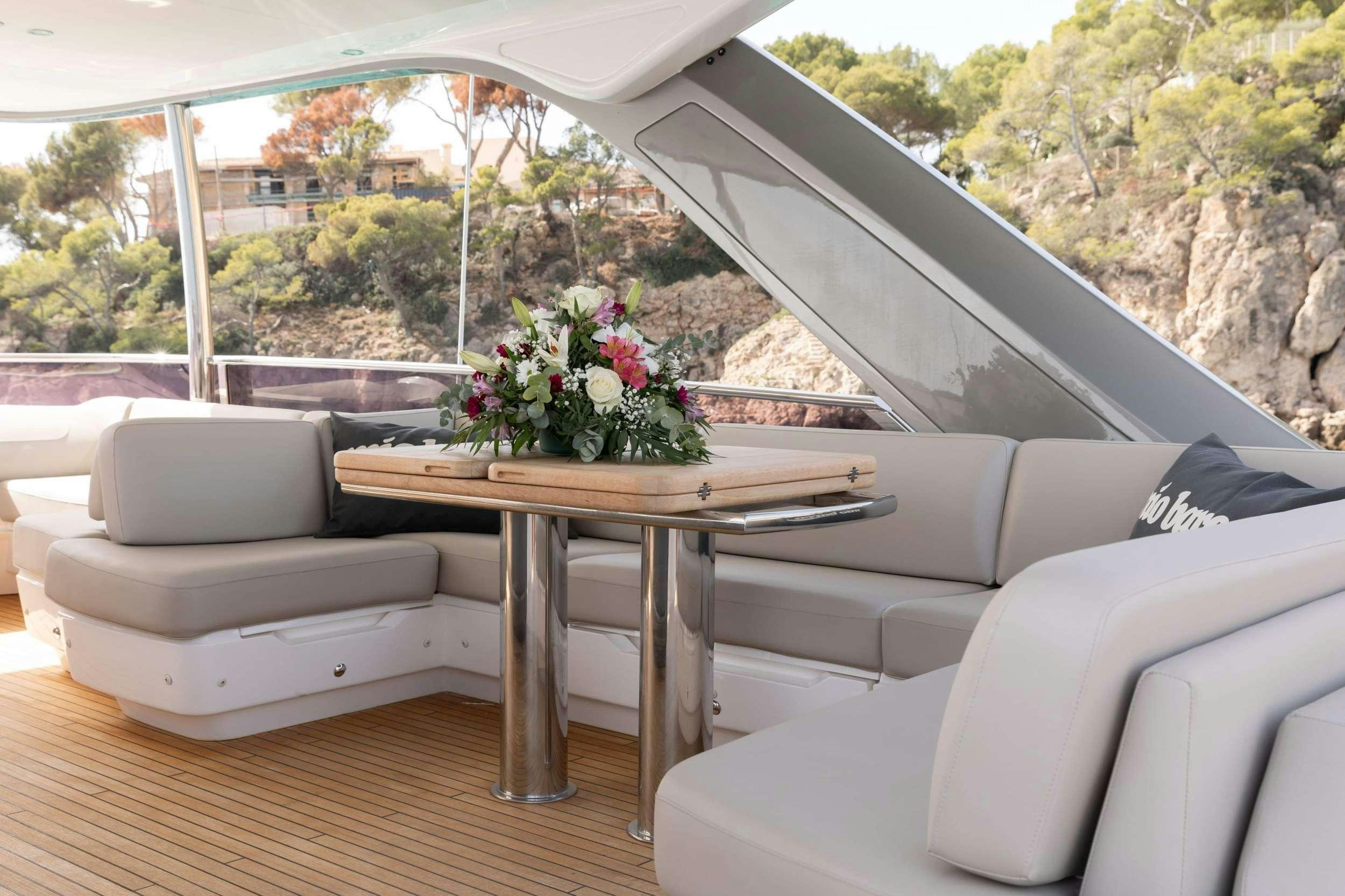 a table and chairs in a room aboard MIO BARCO Yacht for Charter