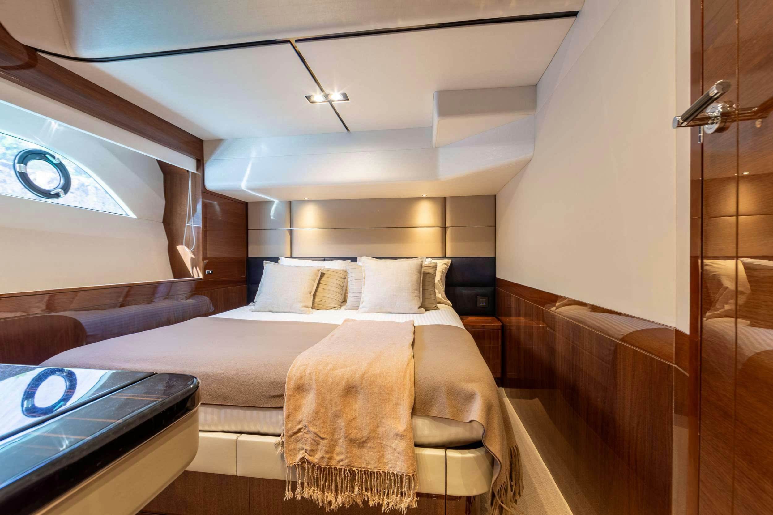 a room with a bed and a window aboard MIO BARCO Yacht for Charter