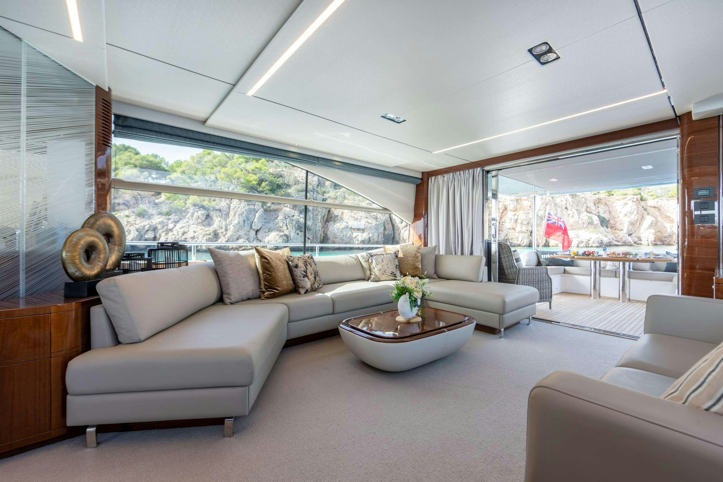a living room with a large window aboard MIO BARCO Yacht for Charter