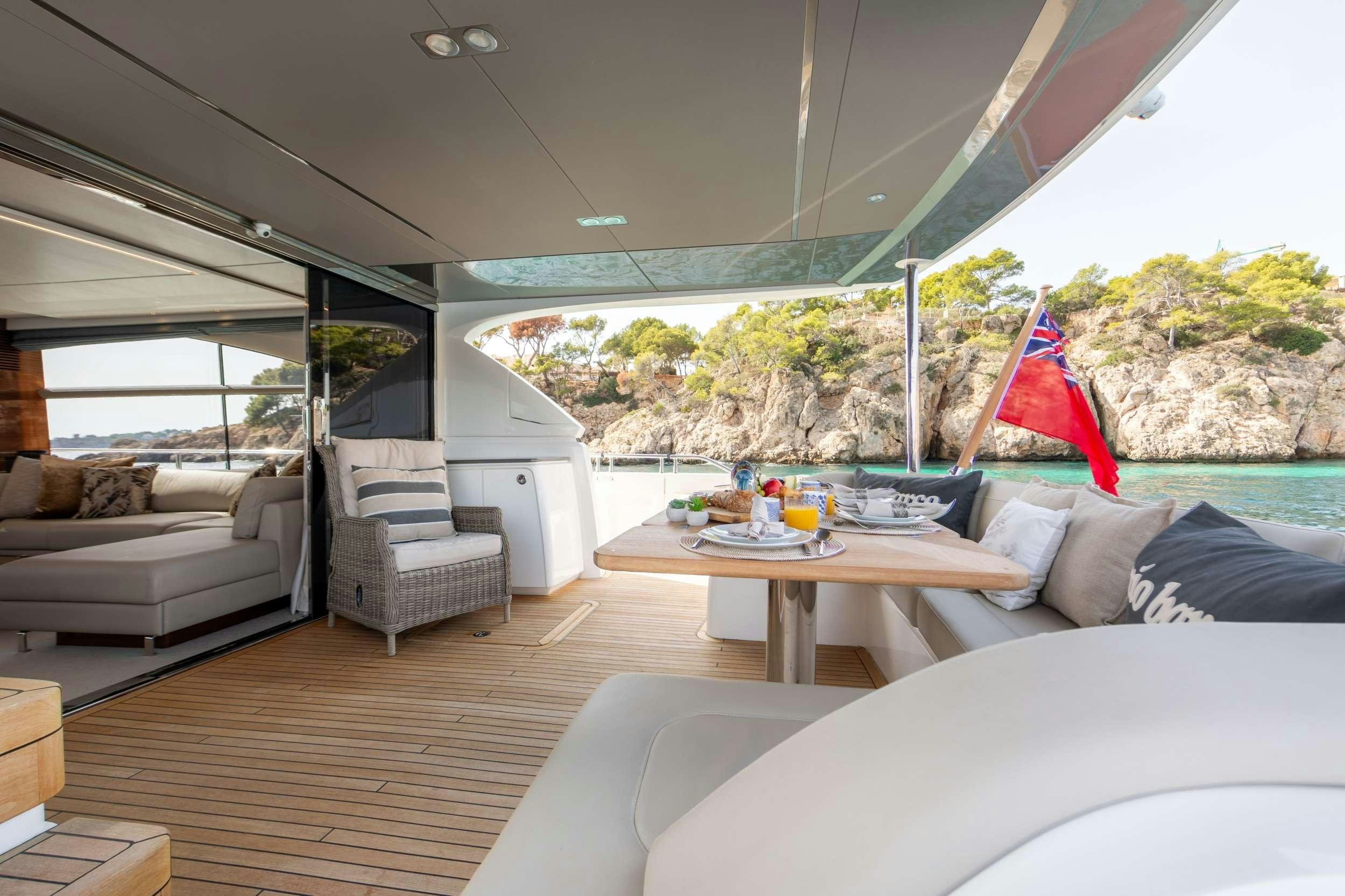 a living room with a large window aboard MIO BARCO Yacht for Charter