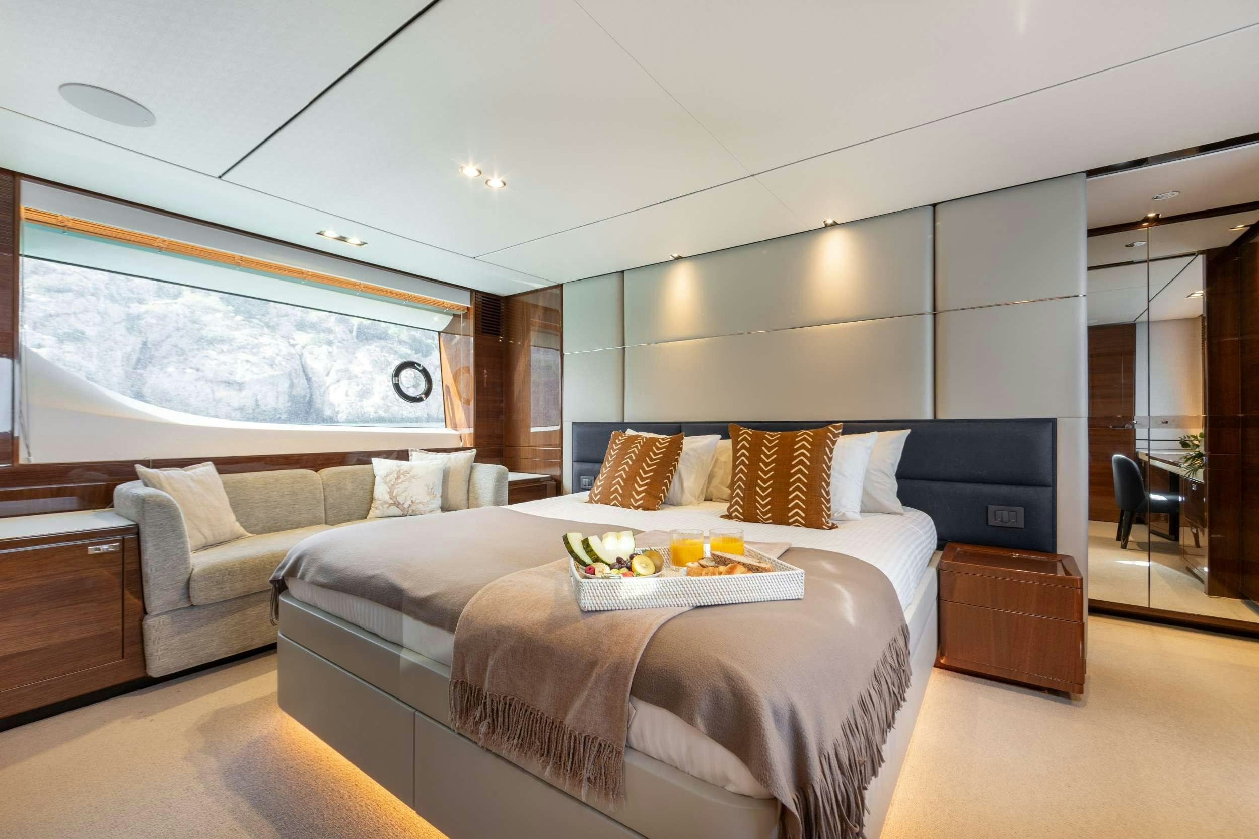 a bedroom with a bed and a tv aboard MIO BARCO Yacht for Charter