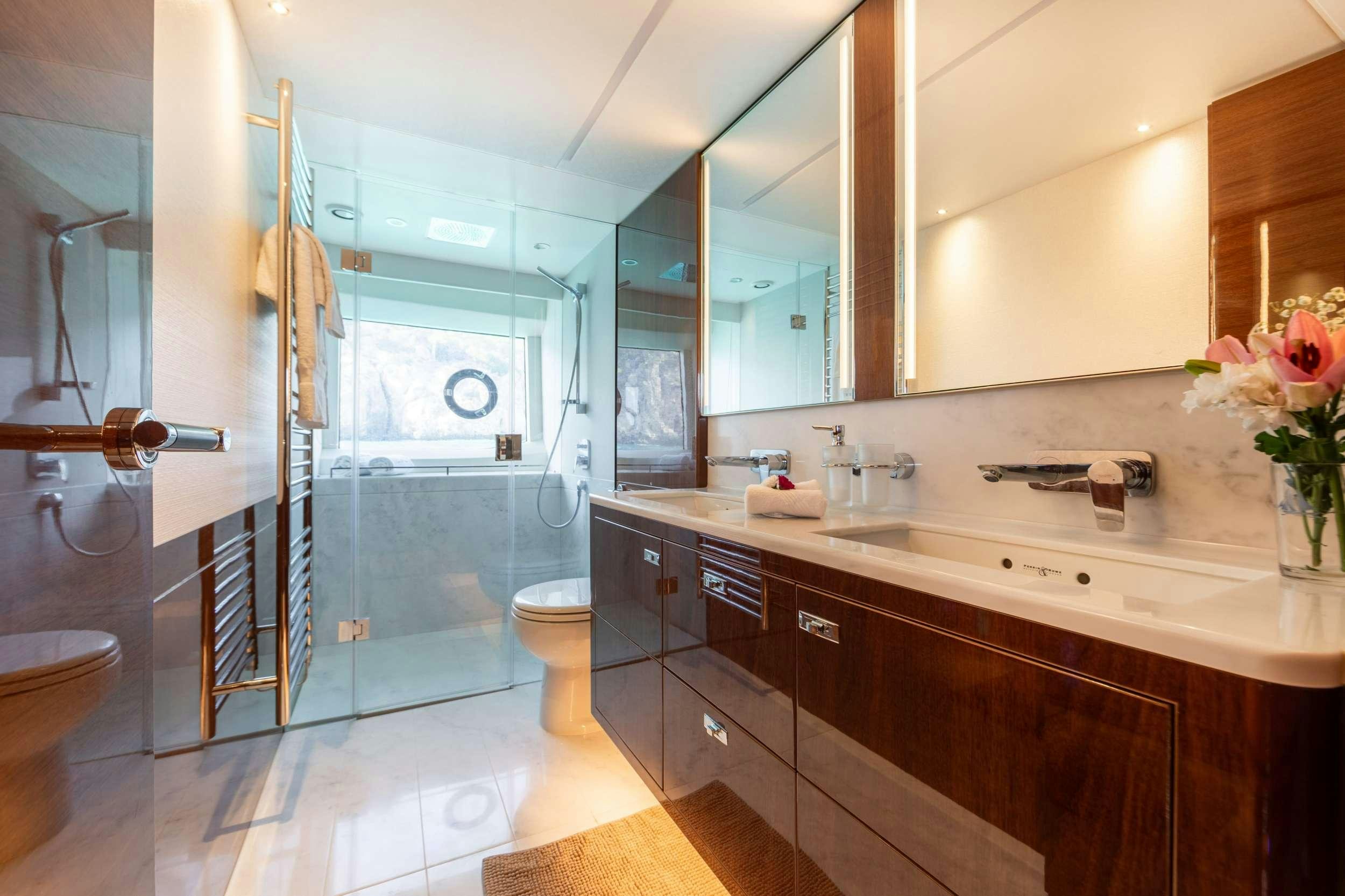 a bathroom with a glass shower aboard MIO BARCO Yacht for Charter