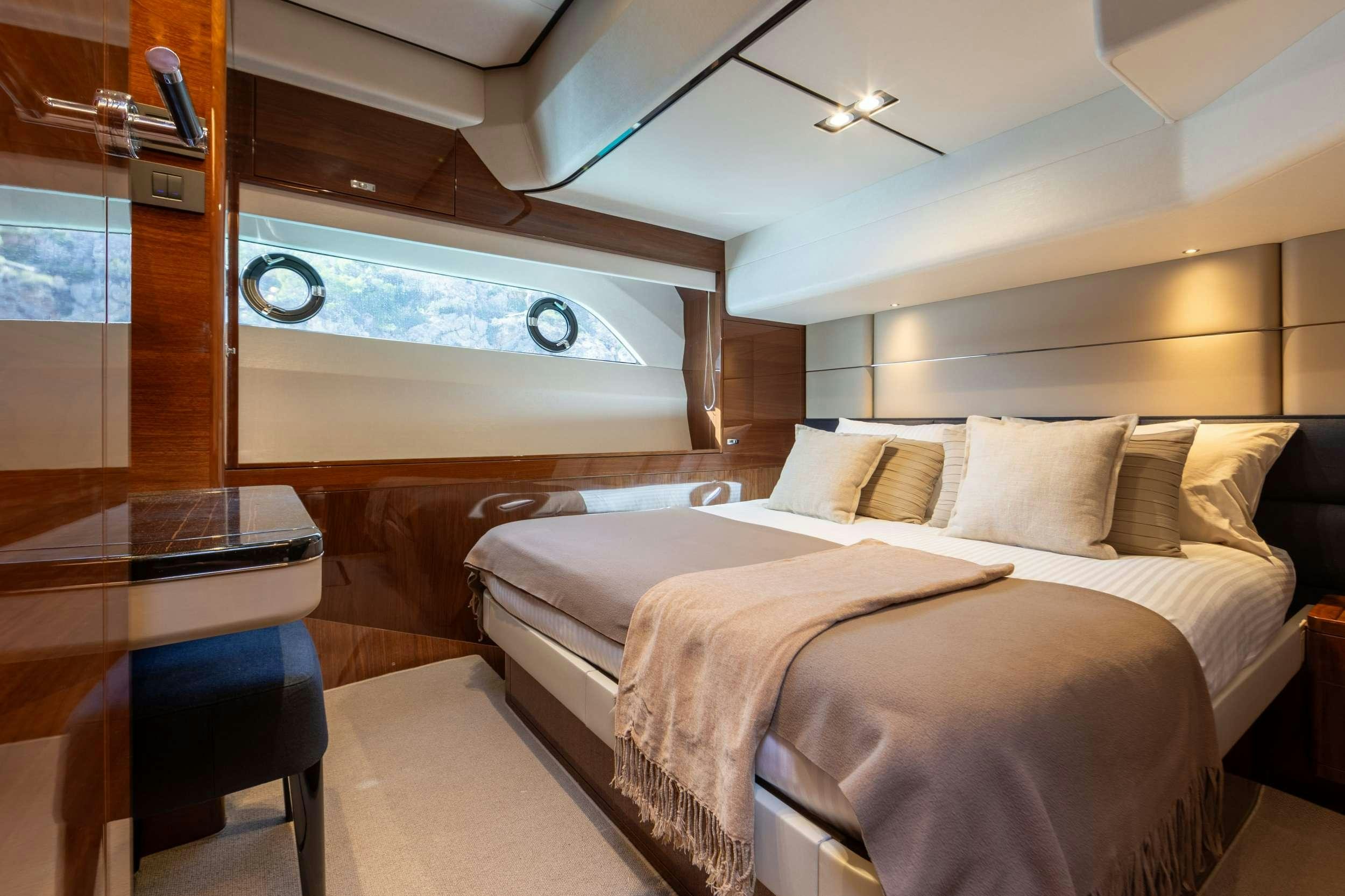 a room with a bed and a window aboard MIO BARCO Yacht for Charter
