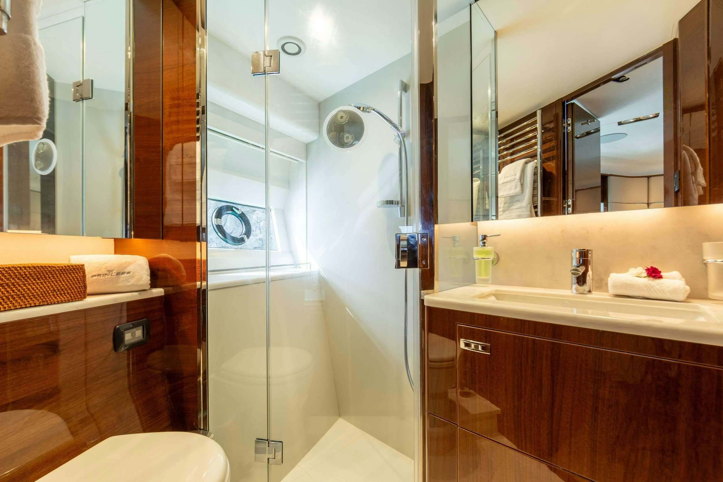 a bathroom with a glass shower aboard MIO BARCO Yacht for Charter