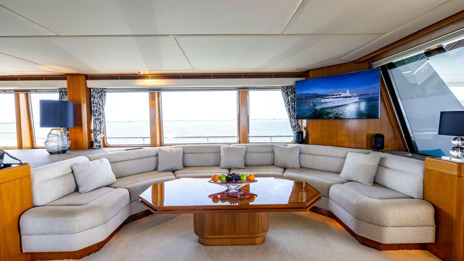 a living room with a large window aboard CAMENA II Yacht for Charter