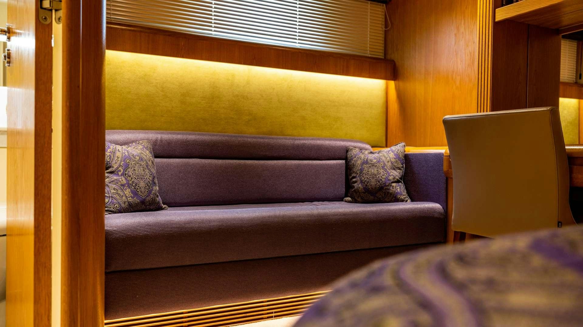 a couch with pillows aboard CAMENA II Yacht for Charter
