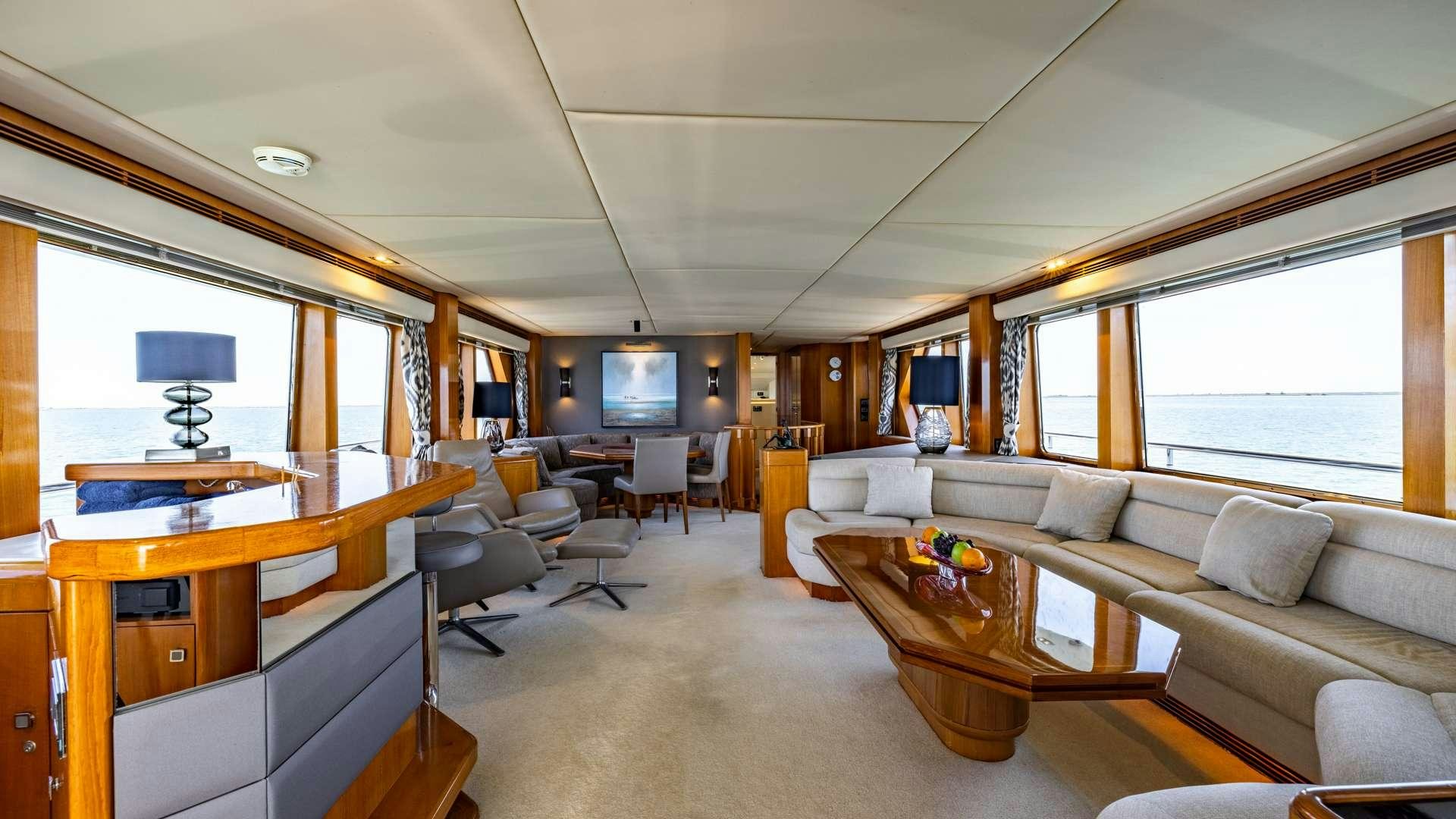 a living room with a couch and a table aboard CAMENA II Yacht for Charter