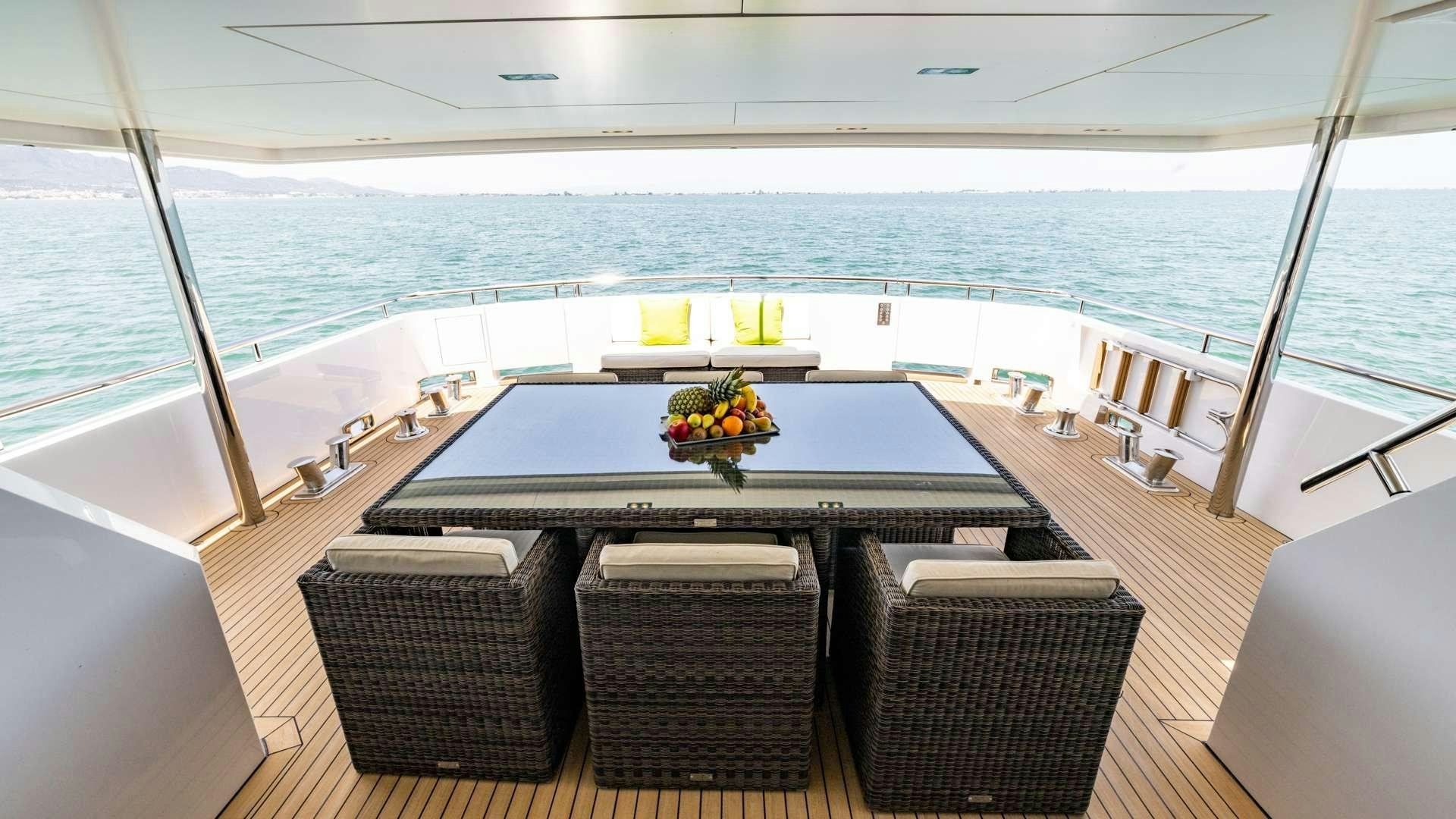 a large room with a table and chairs on it aboard CAMENA II Yacht for Charter