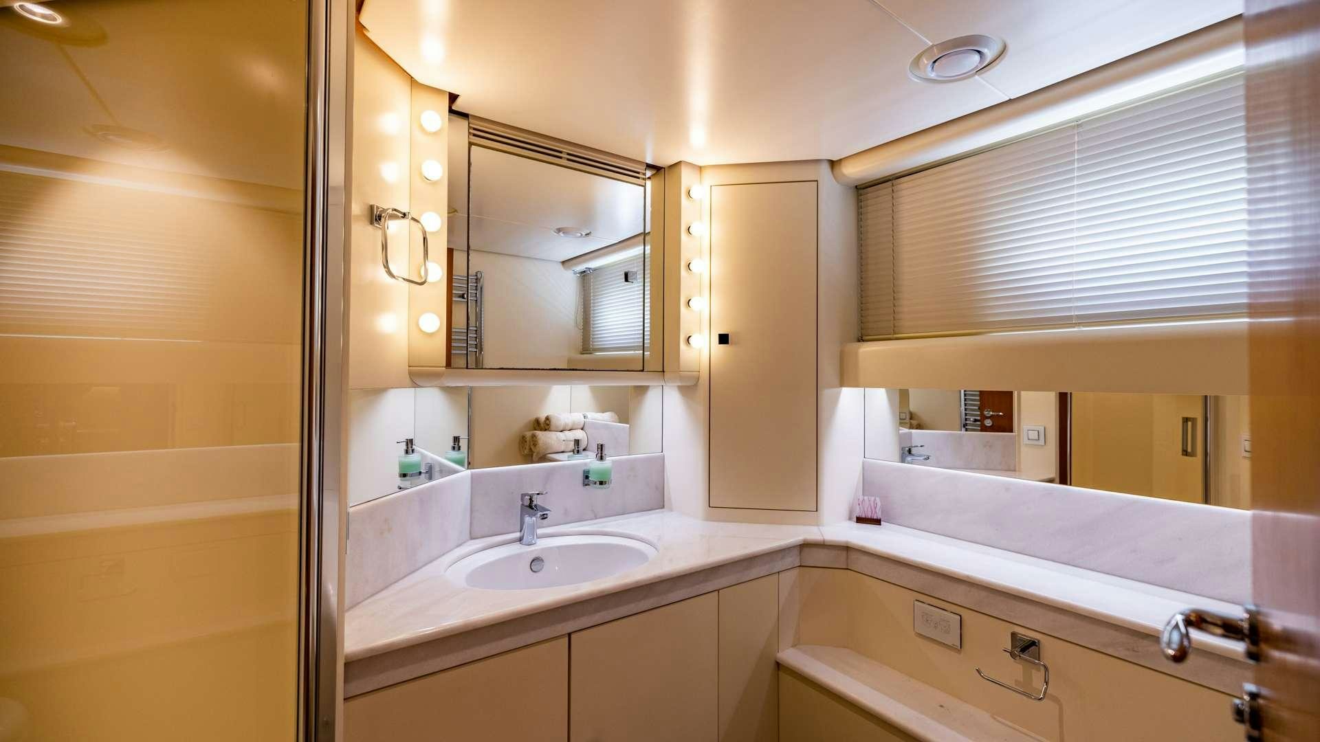 a bathroom with a sink and a mirror aboard CAMENA II Yacht for Charter