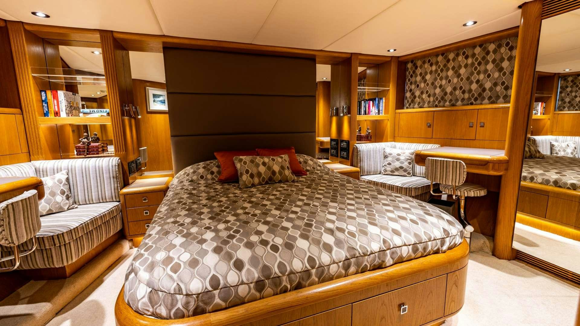 a bedroom with a bed and a desk aboard CAMENA II Yacht for Charter