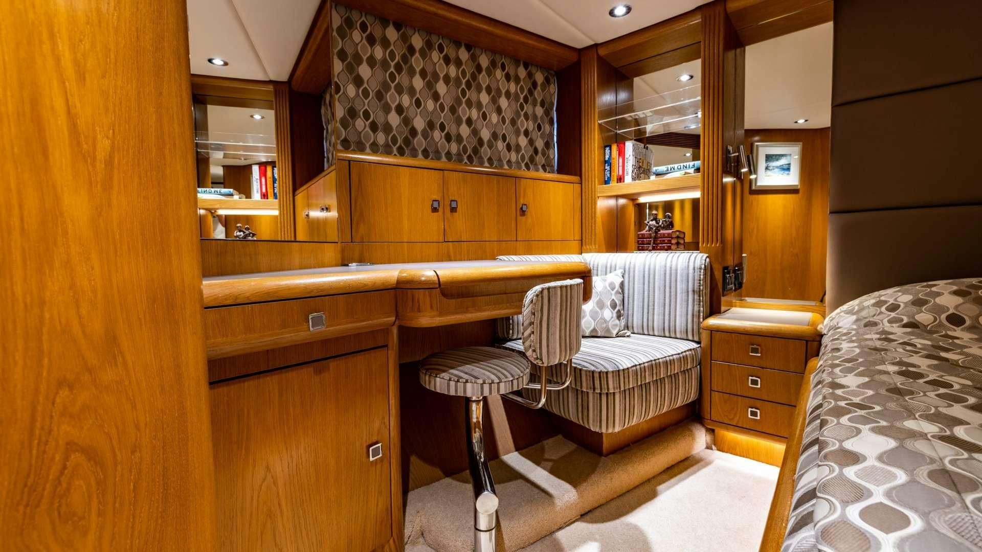 a room with a bed and a desk aboard CAMENA II Yacht for Charter
