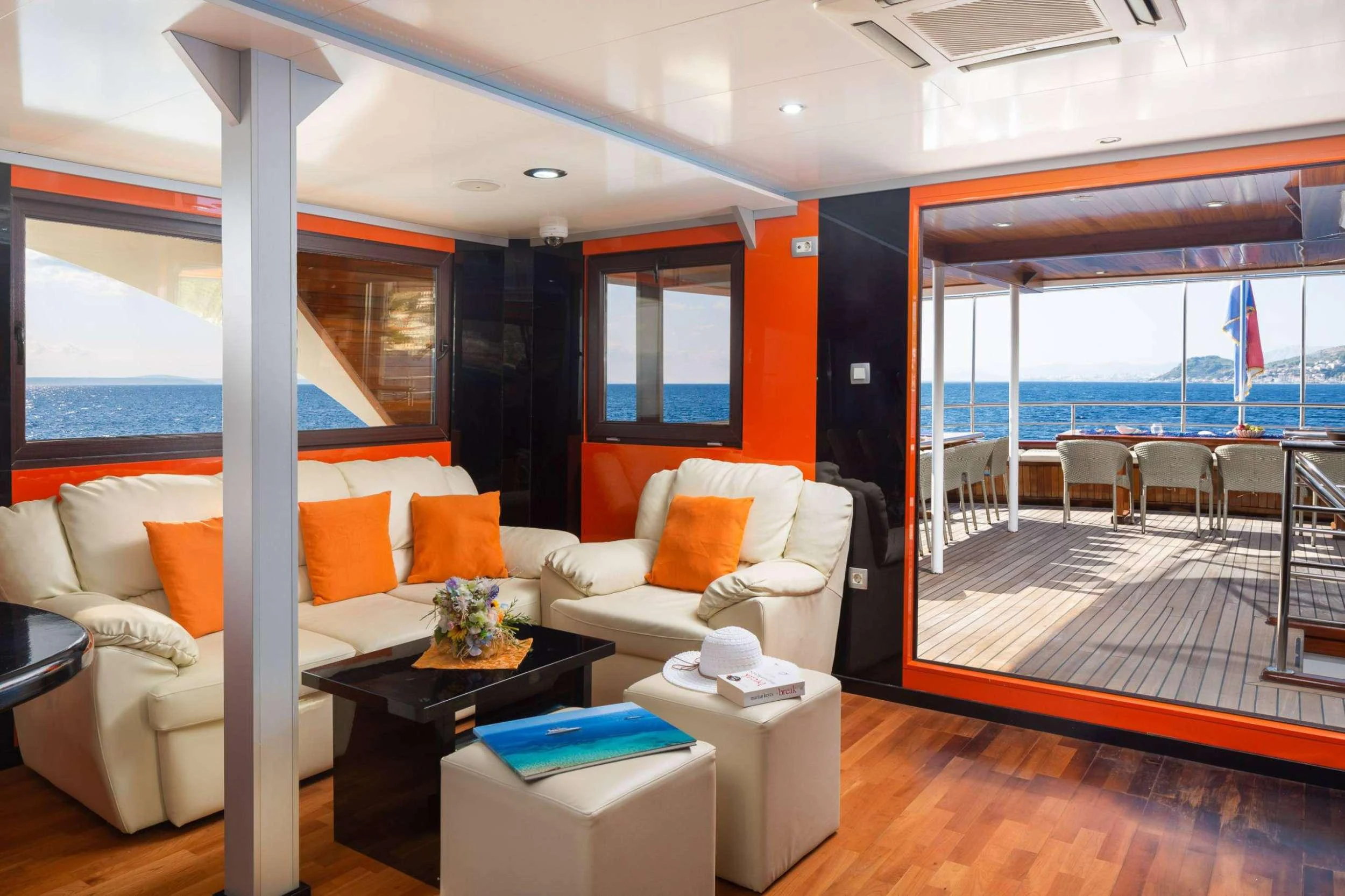 a living room with a large window aboard AMALIA Yacht for Charter