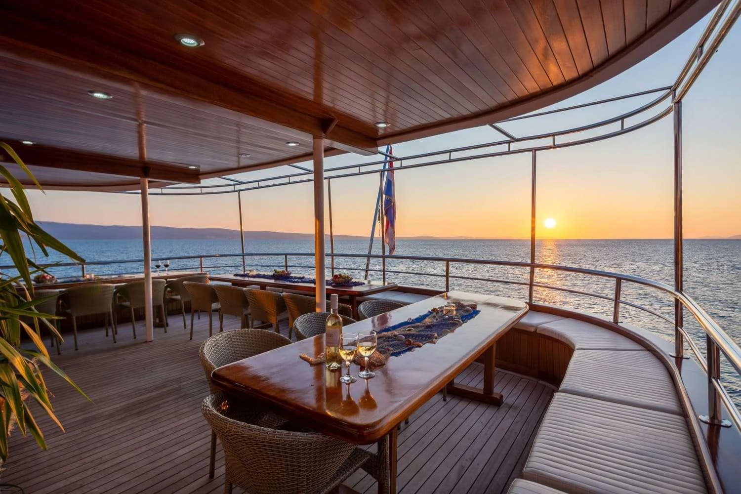 a table on a deck overlooking the ocean aboard AMALIA Yacht for Charter