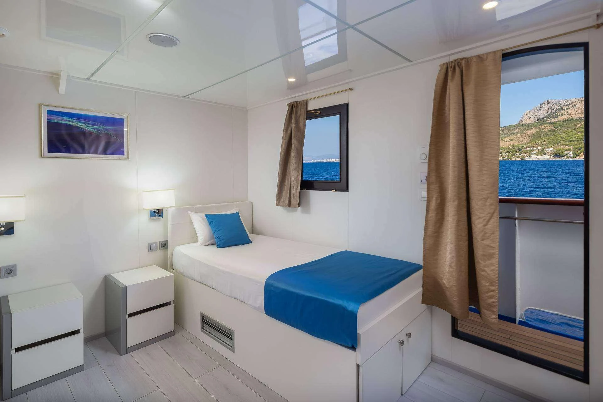 a room with a bed and a window aboard AMALIA Yacht for Charter
