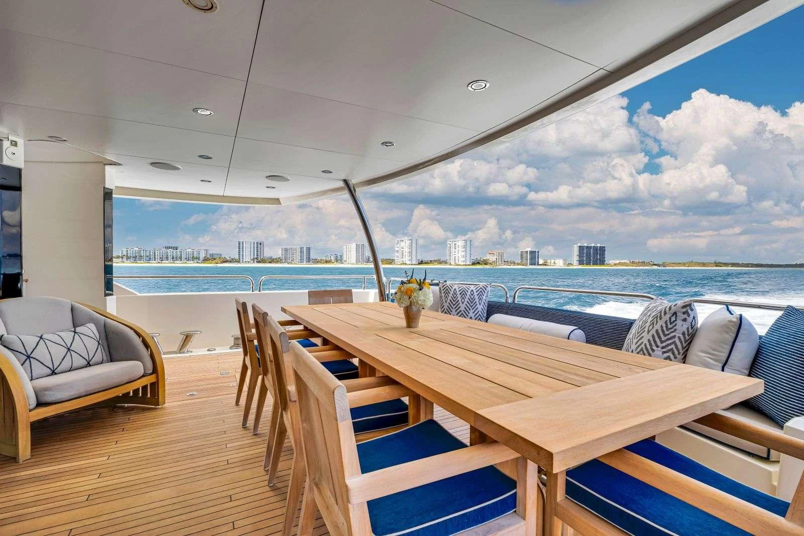 a table and chairs on a deck aboard NATURAL 9 Yacht for Charter