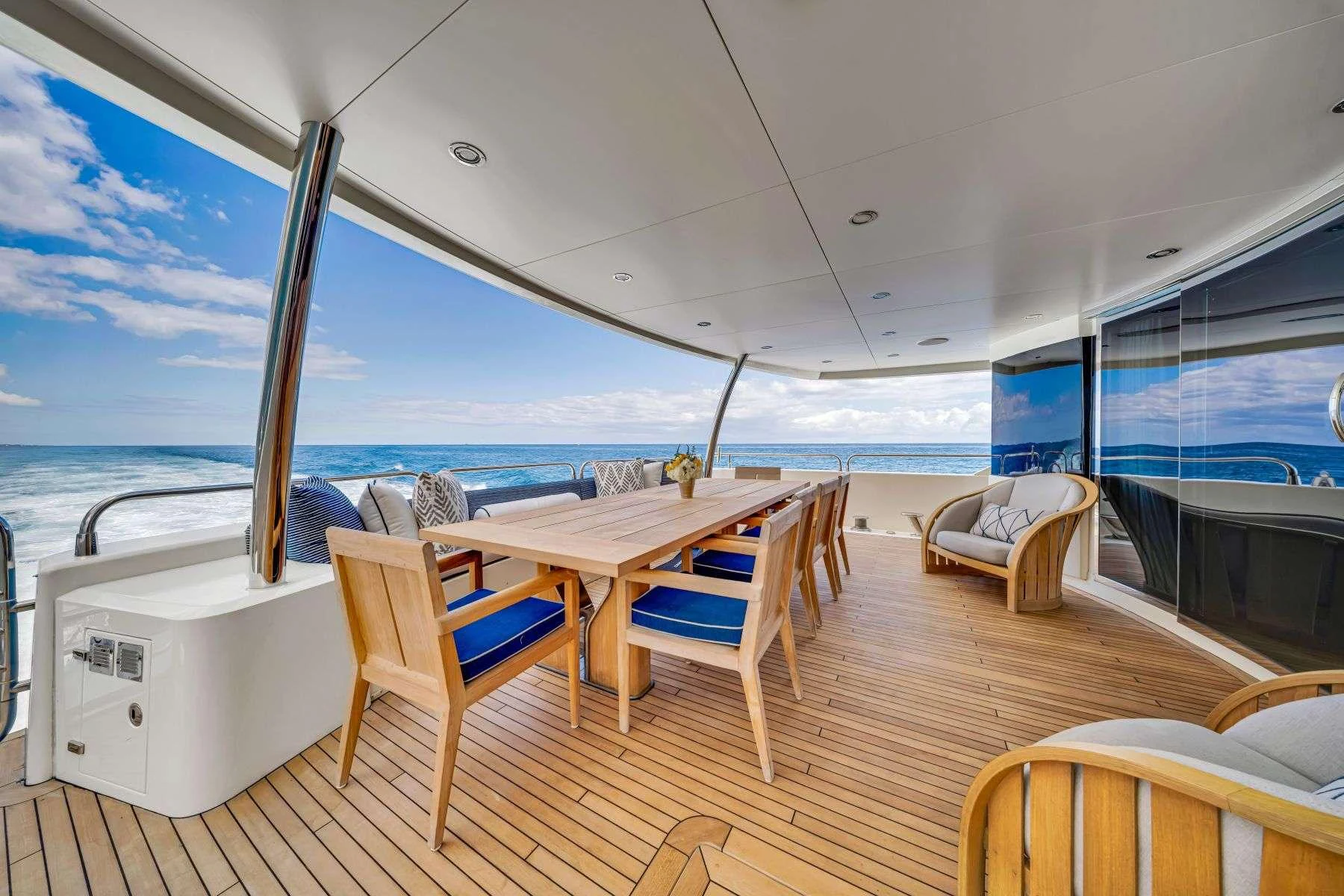 a table and chairs on a deck aboard NATURAL 9 Yacht for Charter
