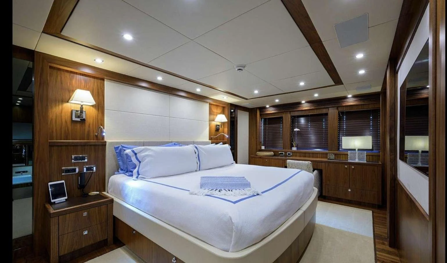 a room with a bed and a desk aboard NATURAL 9 Yacht for Charter