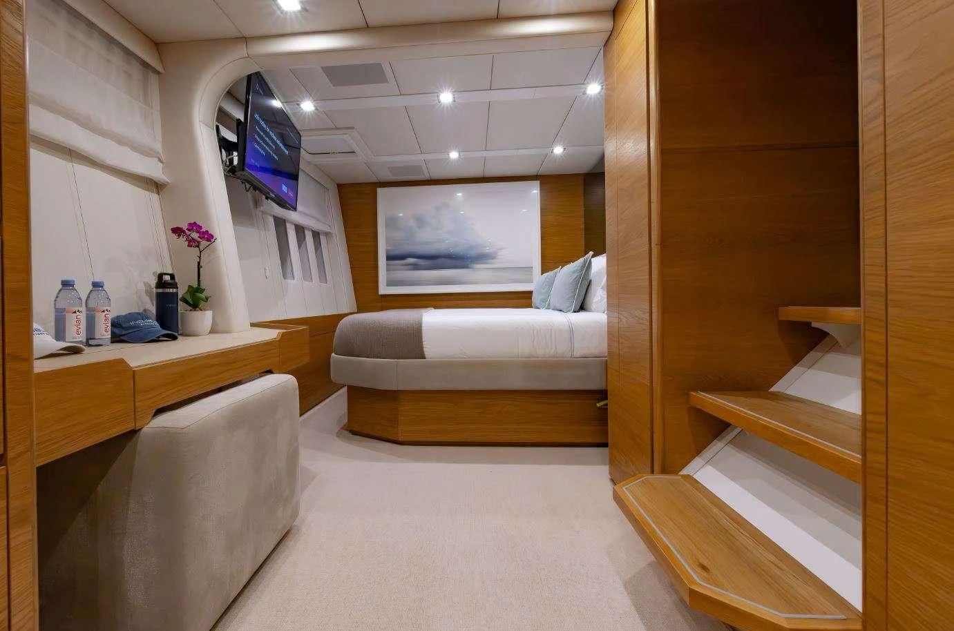 a room with a couch and a television on the wall aboard DIANA Yacht for Charter