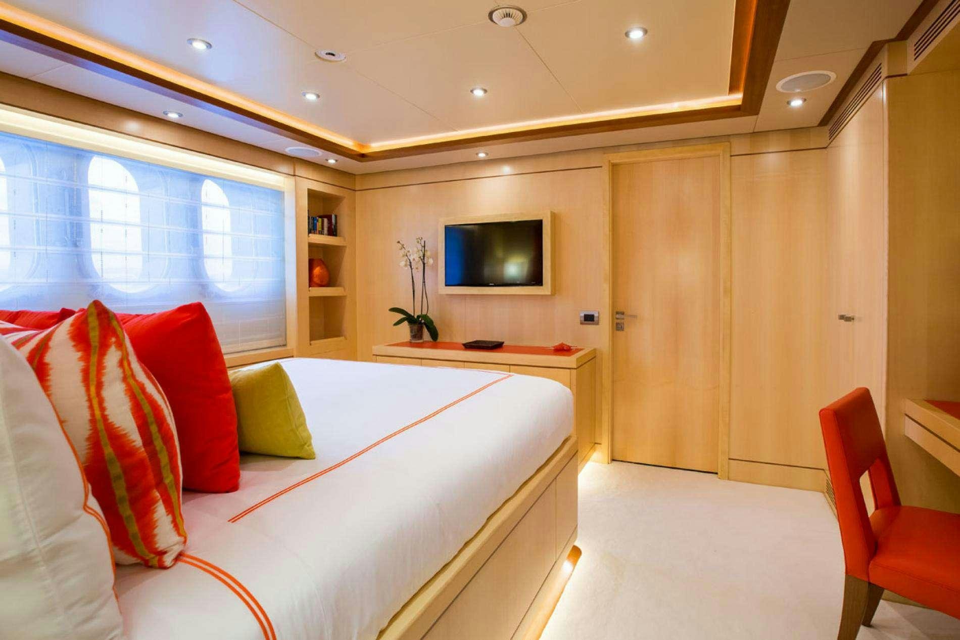 a room with a bed and a tv aboard ARTHUR'S WAY Yacht for Charter
