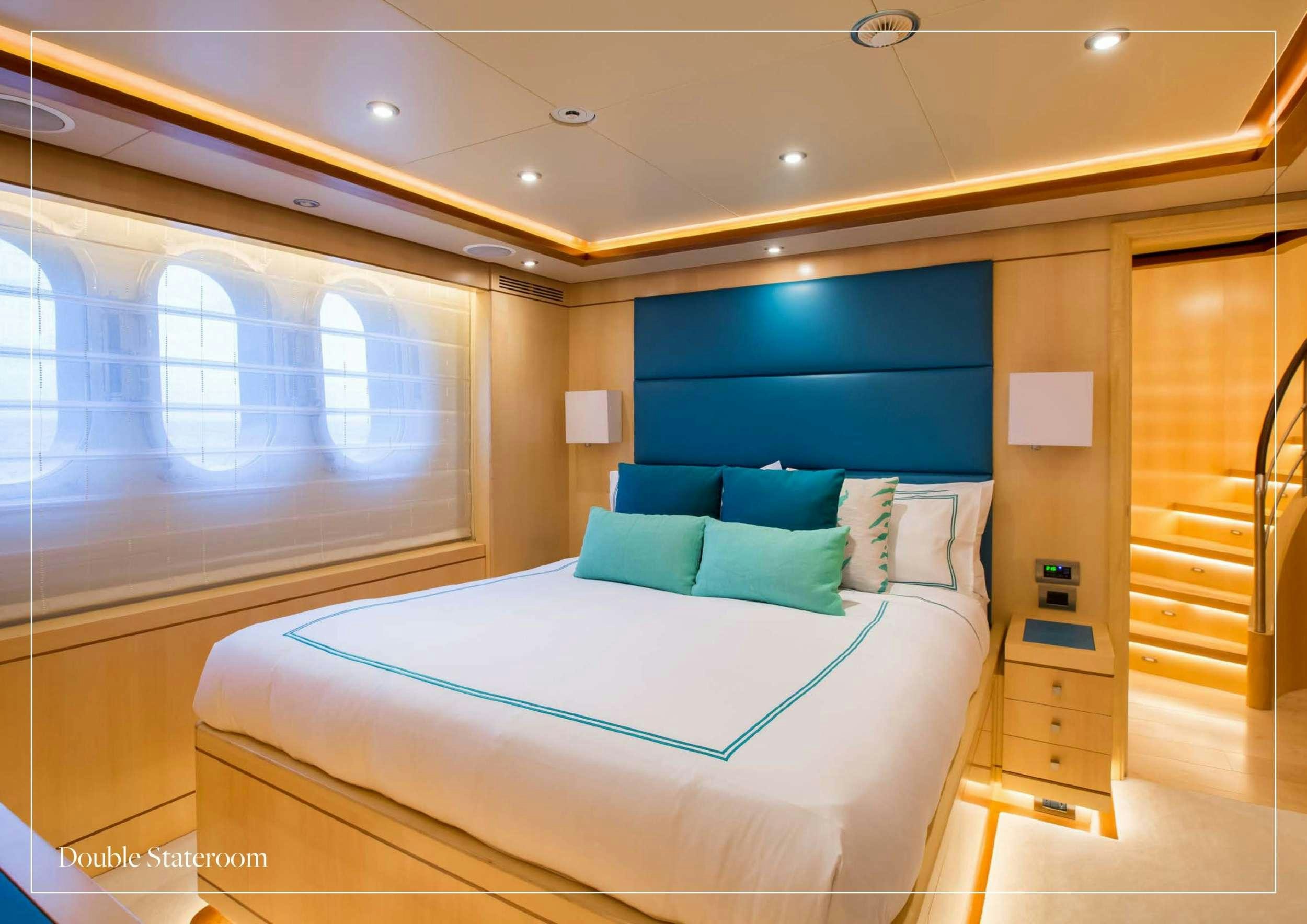 a room with a bed and a window aboard ARTHUR'S WAY Yacht for Charter