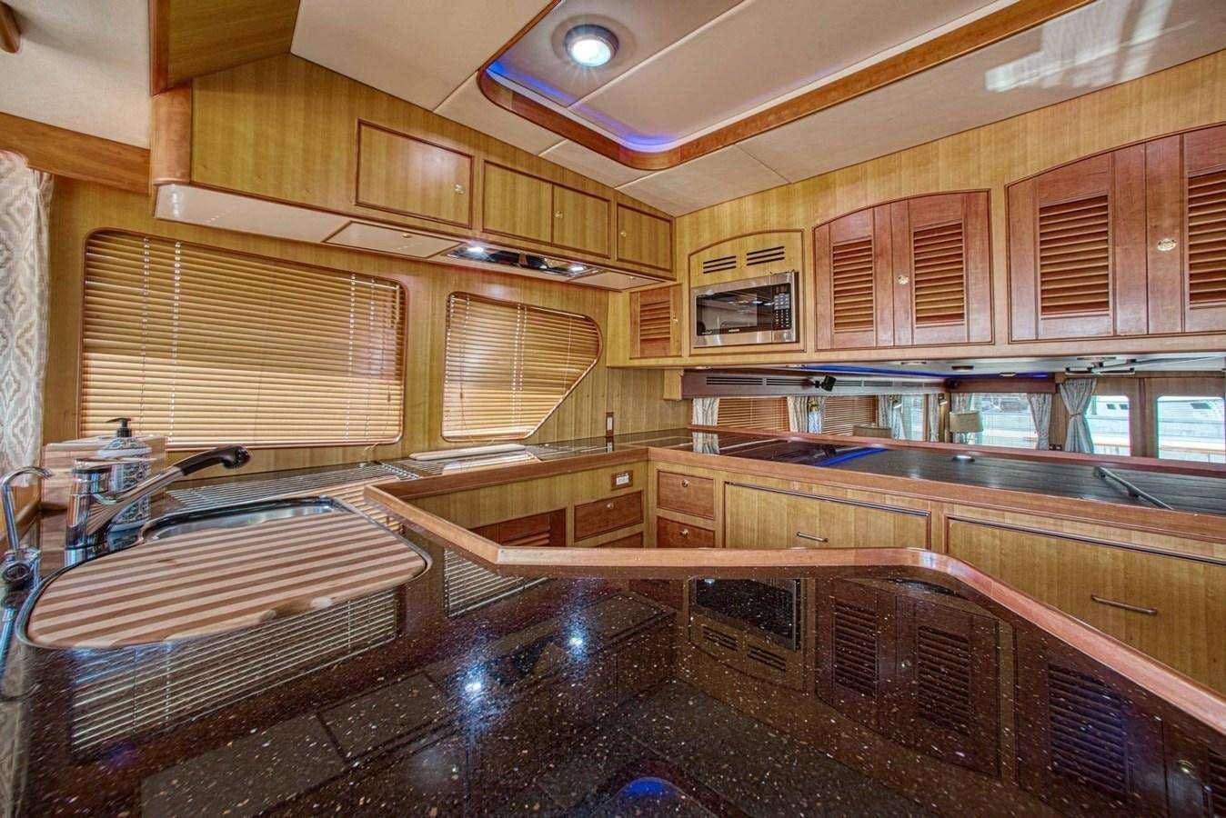a kitchen with wooden cabinets aboard WHAT'S NEXT Yacht for Charter