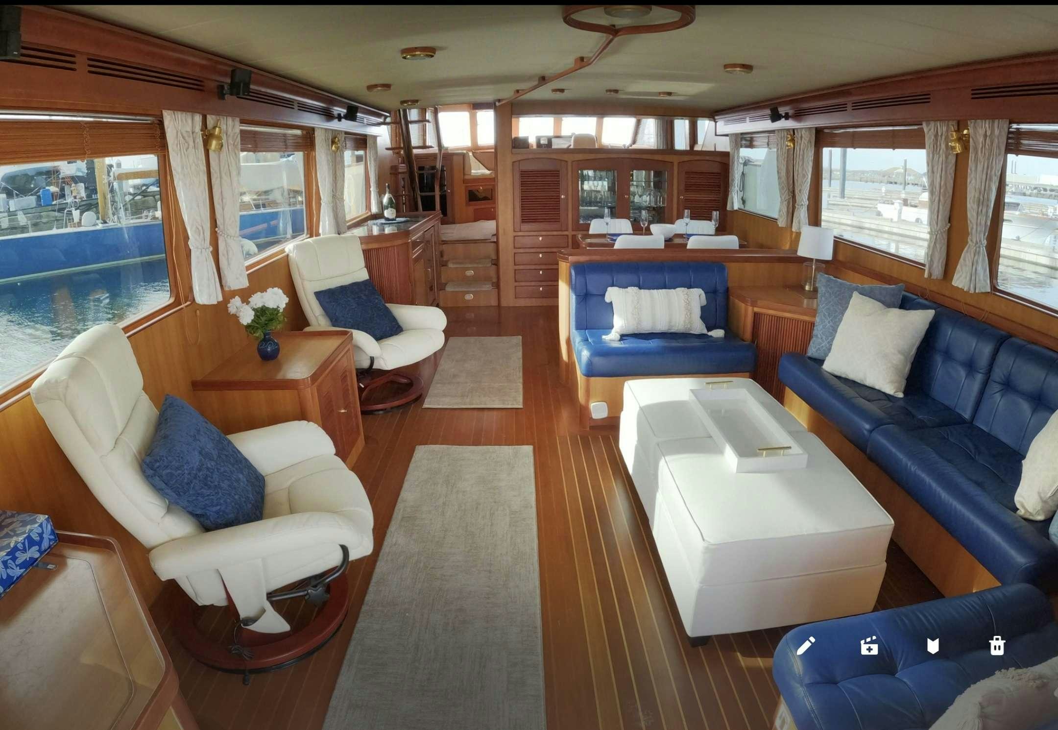 a living room with a blue couch aboard WHAT'S NEXT Yacht for Charter