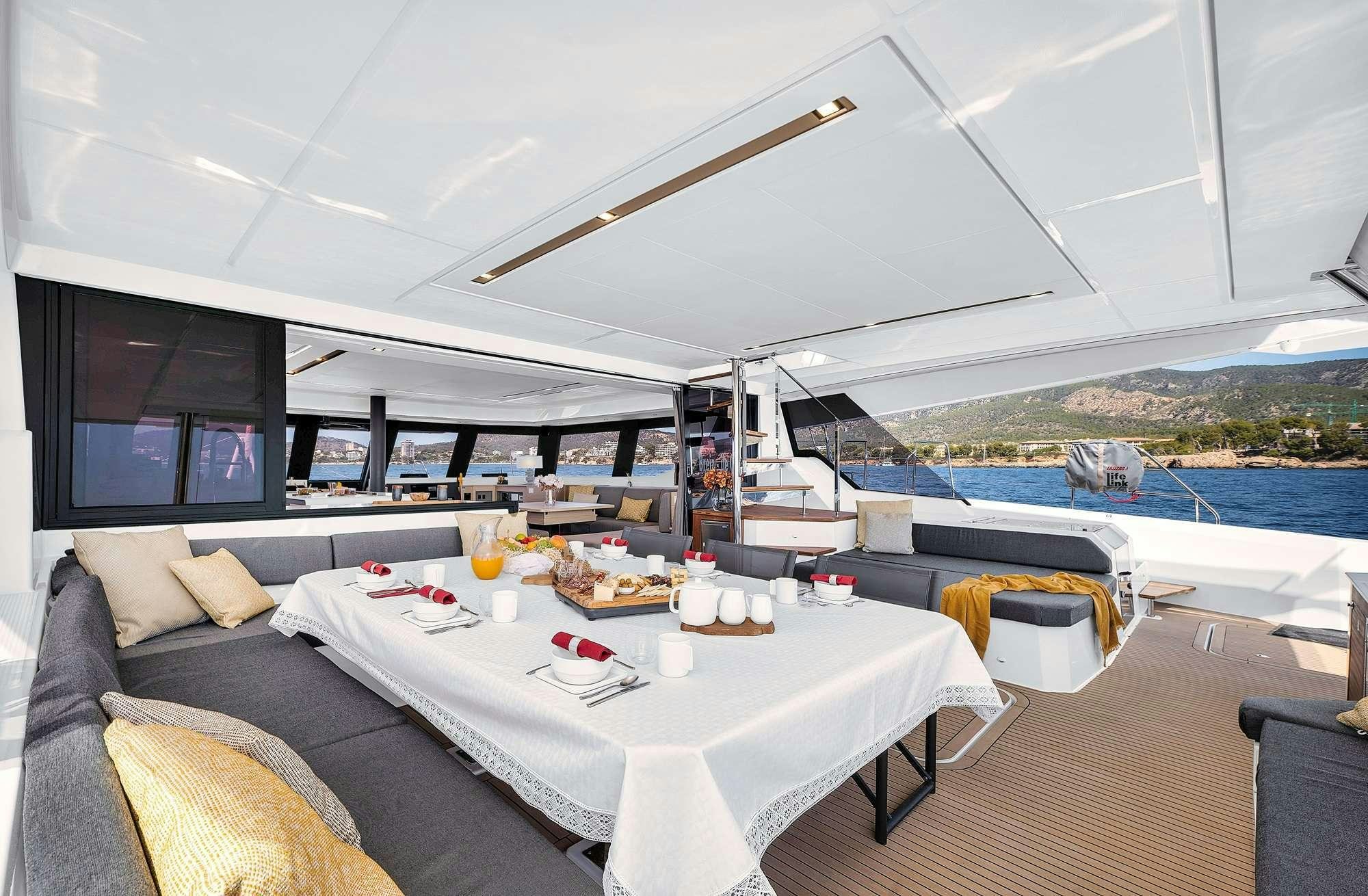 a room with a table and chairs aboard ALEGRIA 67 Yacht for Charter