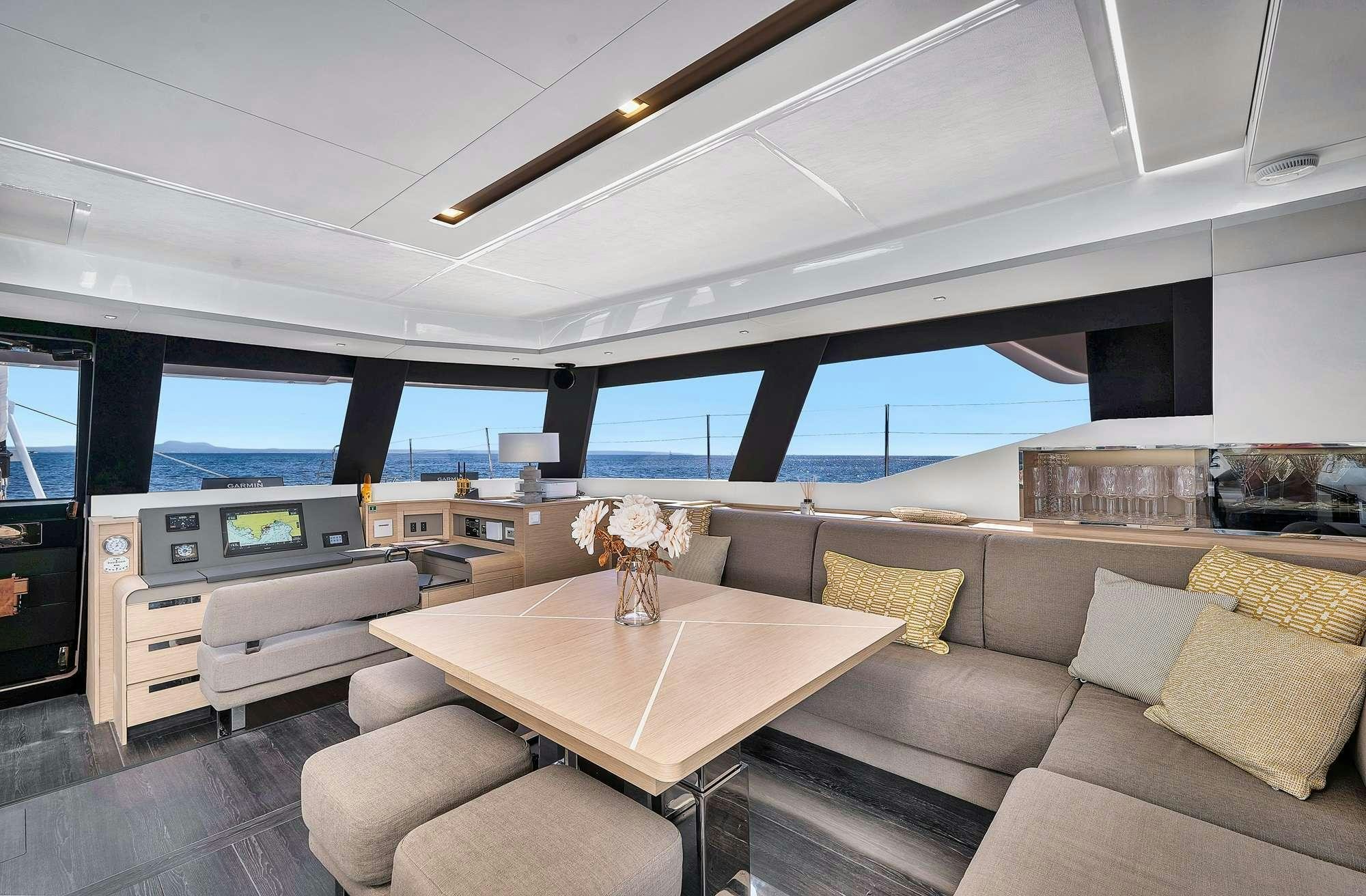 a living room with a couch and a table aboard ALEGRIA 67 Yacht for Charter