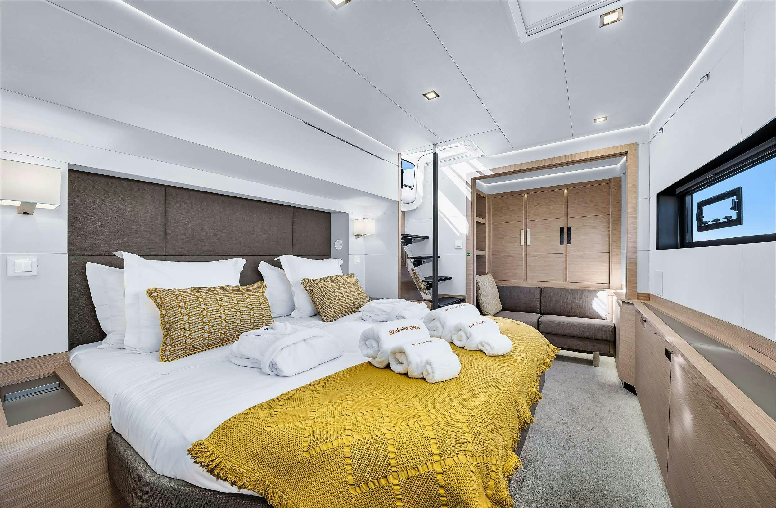 a room with a bed and a dresser aboard ALEGRIA 67 Yacht for Charter