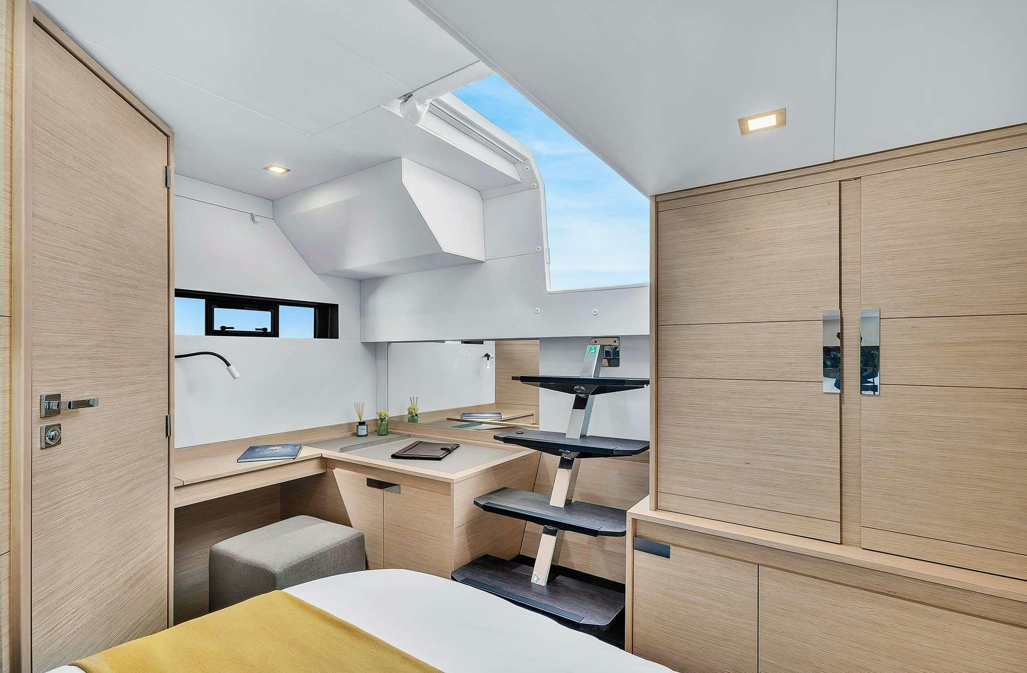 a room with a desk and a shelf with a bookcase aboard ALEGRIA 67 Yacht for Charter