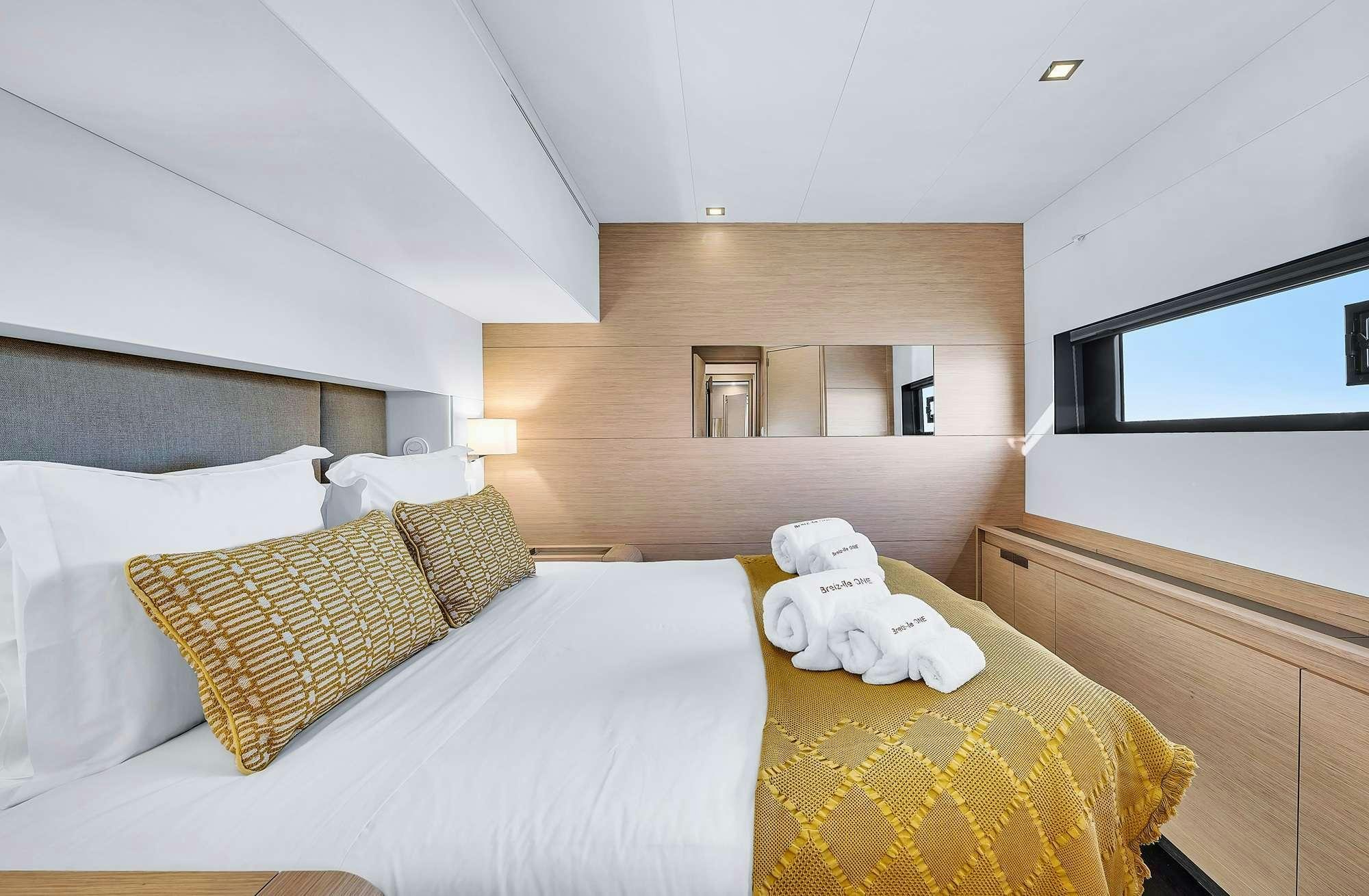 a bed with a stuffed animal on it aboard ALEGRIA 67 Yacht for Charter