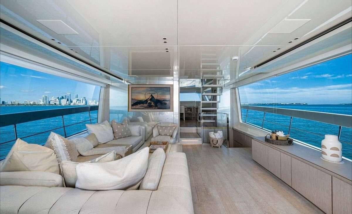 a living room with a large window aboard 2019 SANLORENZO SX76 #16 Yacht for Charter