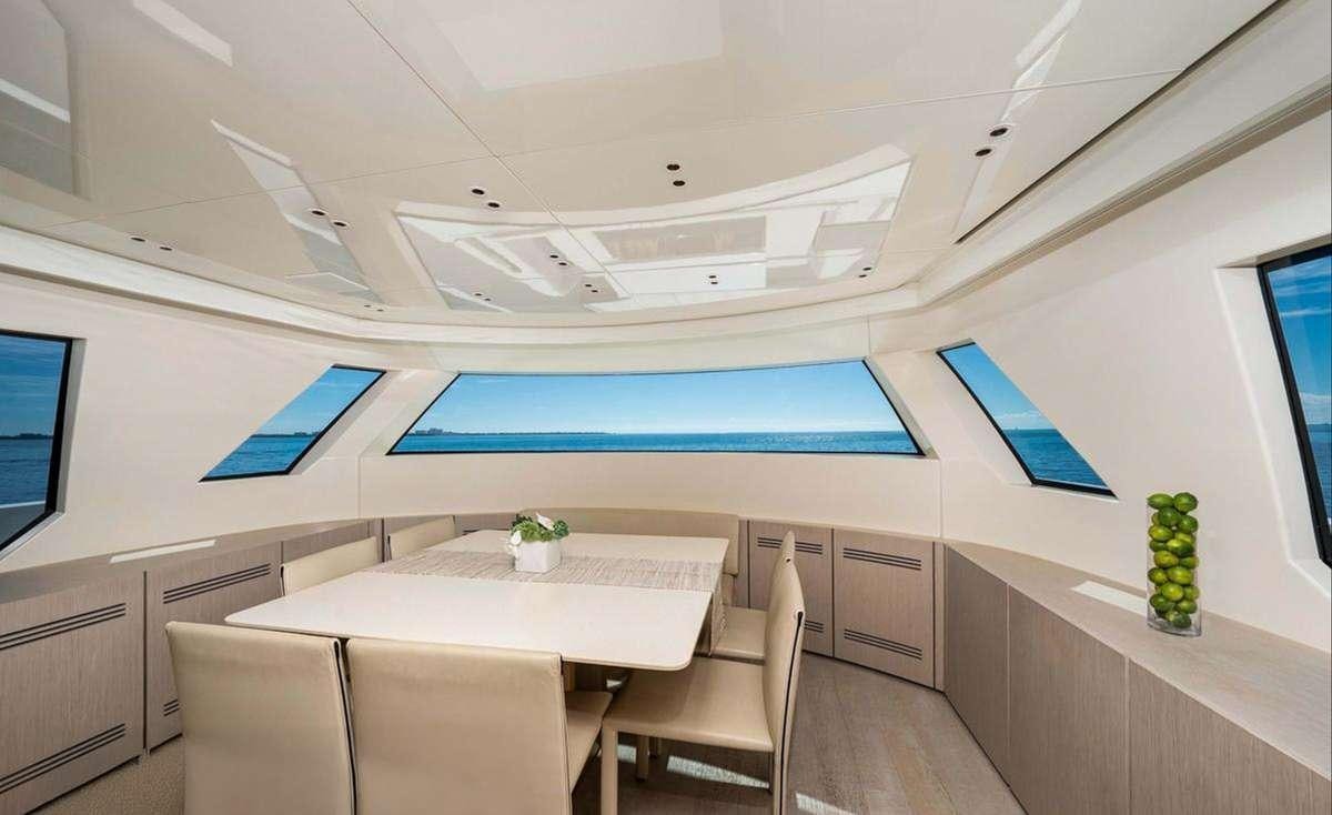 a room with a table and chairs aboard 2019 SANLORENZO SX76 #16 Yacht for Charter