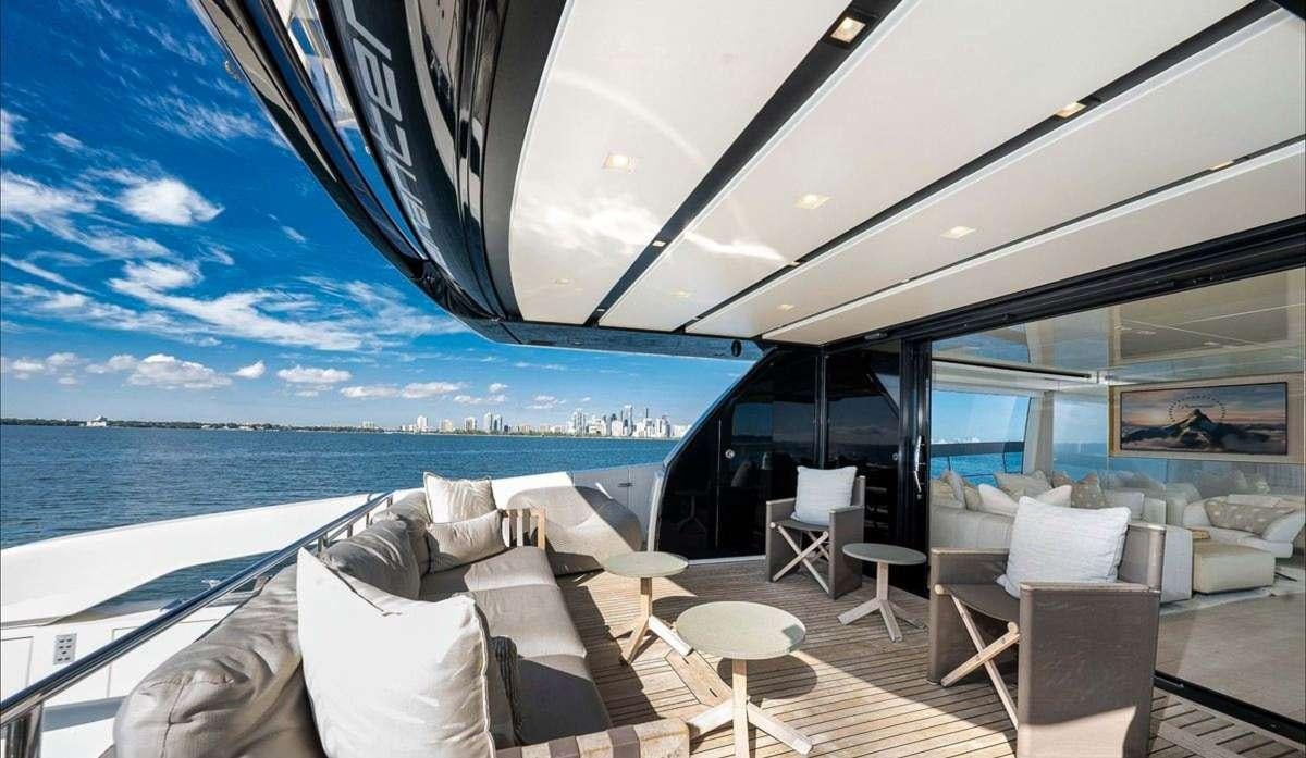 a boat with white chairs and a large body of water in the background aboard 2019 SANLORENZO SX76 #16 Yacht for Charter