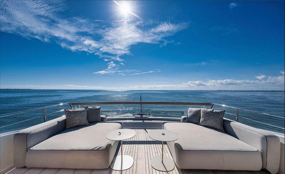 a lounge chair on a balcony overlooking a body of water aboard 2019 SANLORENZO SX76 #16 Yacht for Charter