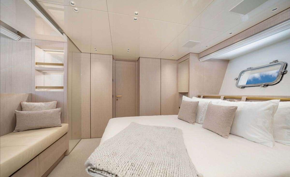 a room with a bed and a mirror aboard 2019 SANLORENZO SX76 #16 Yacht for Charter