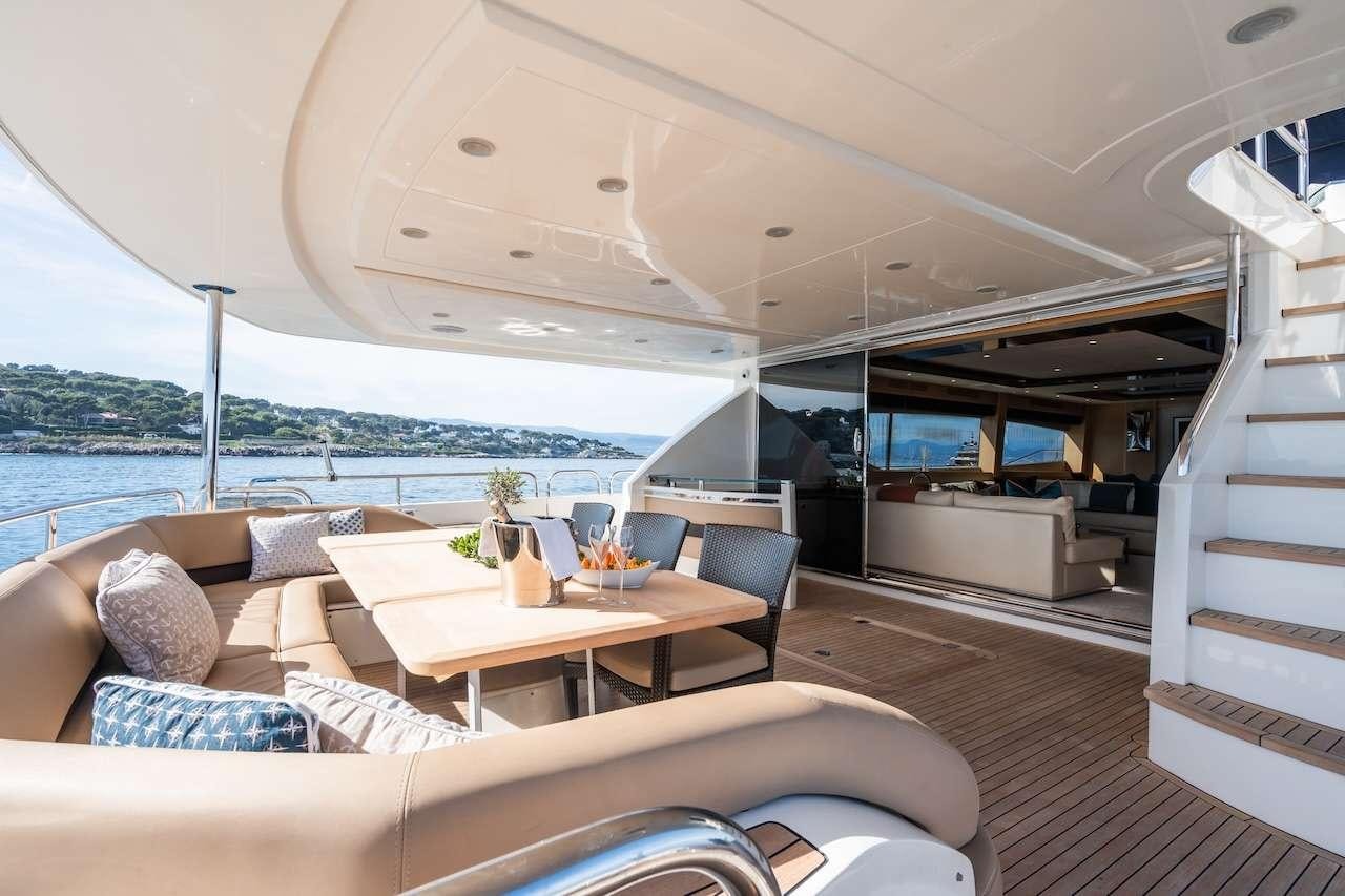 a room with a couch and a table and a view of the ocean aboard BLUE EYES Yacht for Charter