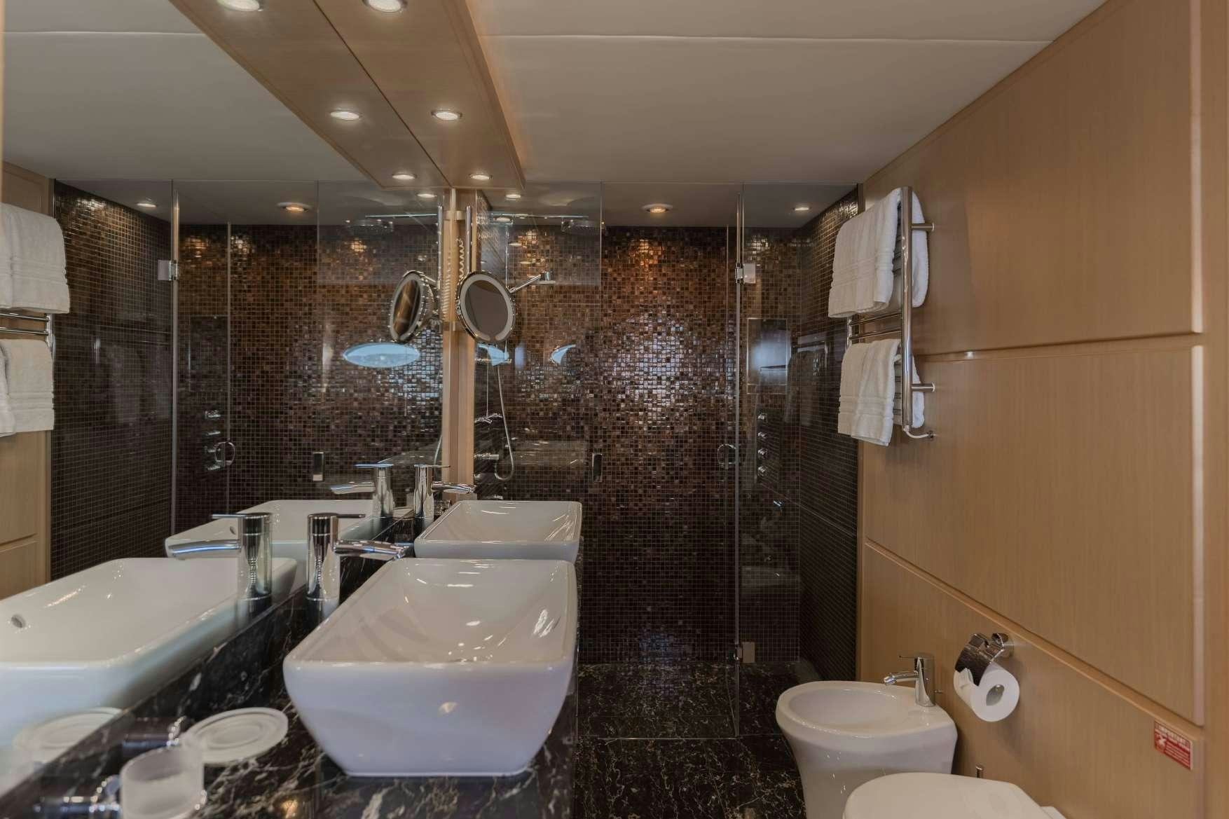 a bathroom with a large mirror aboard BLUE EYES Yacht for Charter