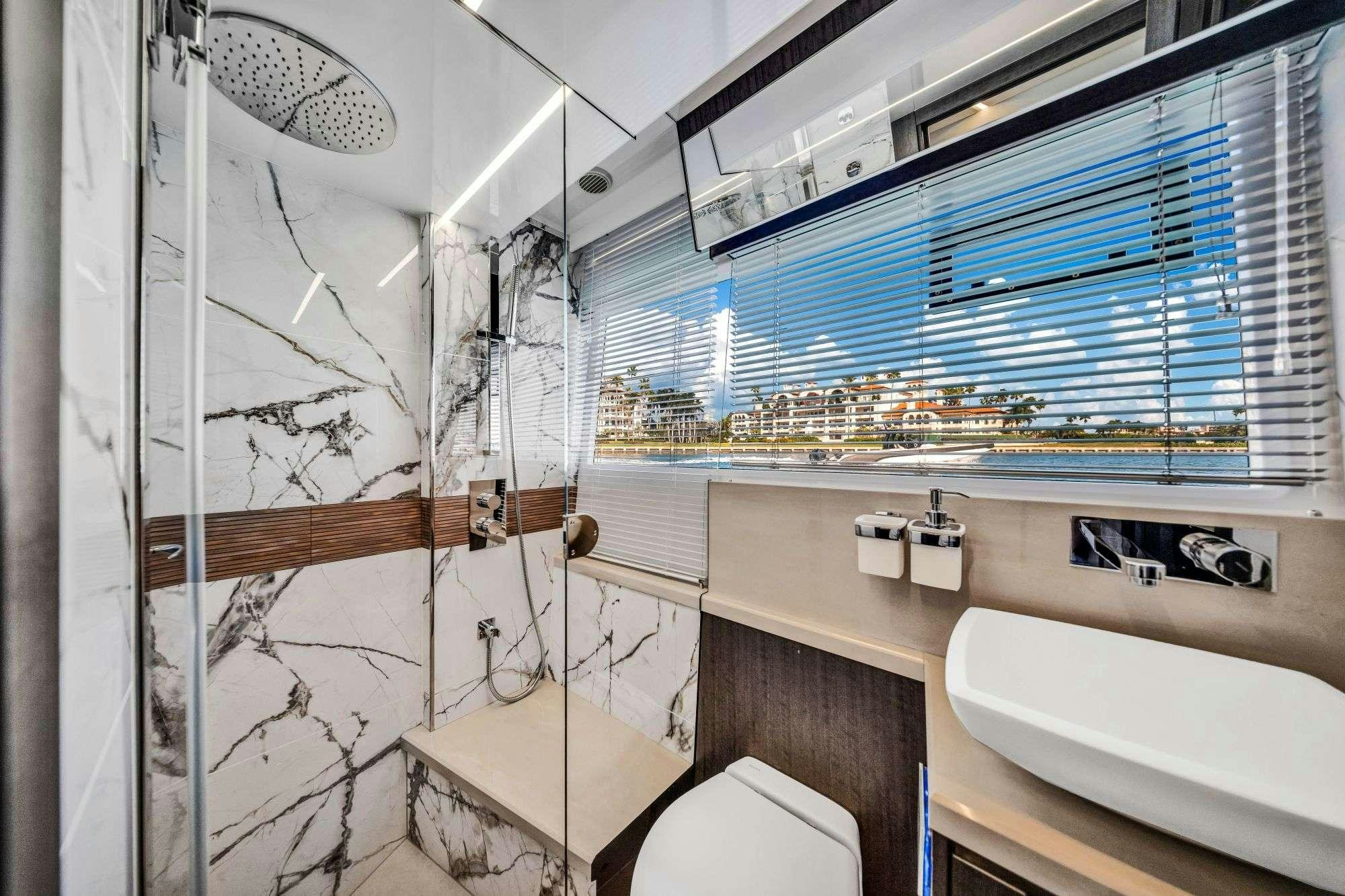 a bathroom with a glass shower aboard OPTIMUS PRIME Yacht for Charter
