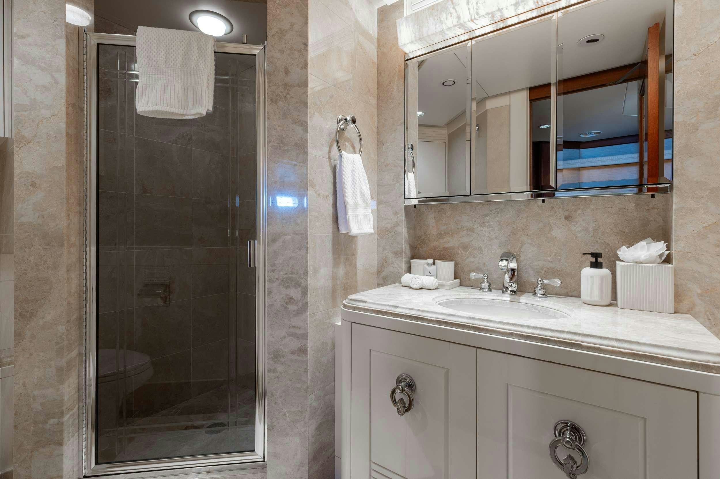 a bathroom with a glass shower aboard LANIDA Yacht for Charter