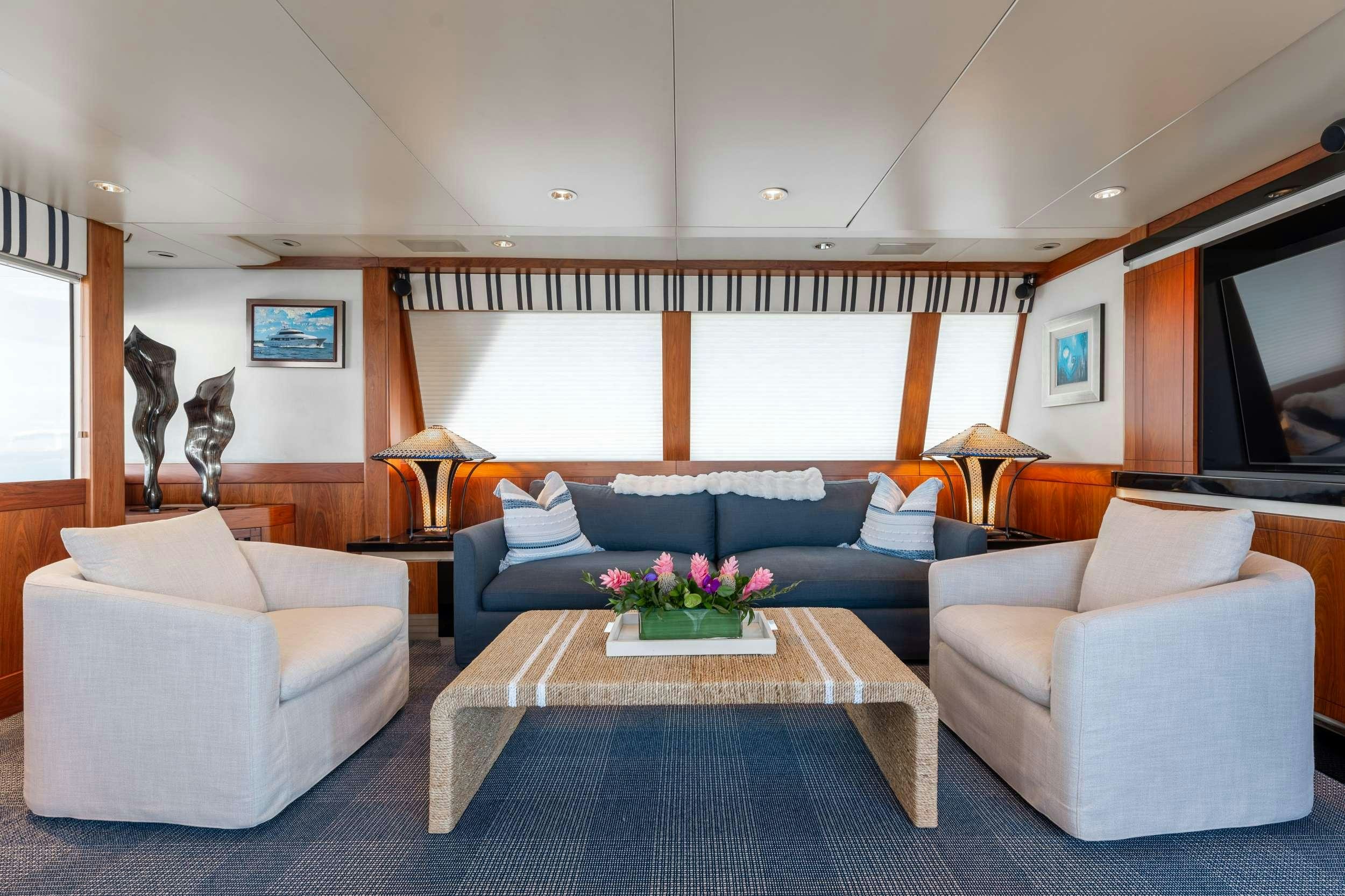 a living room with a table and couches aboard LANIDA Yacht for Charter