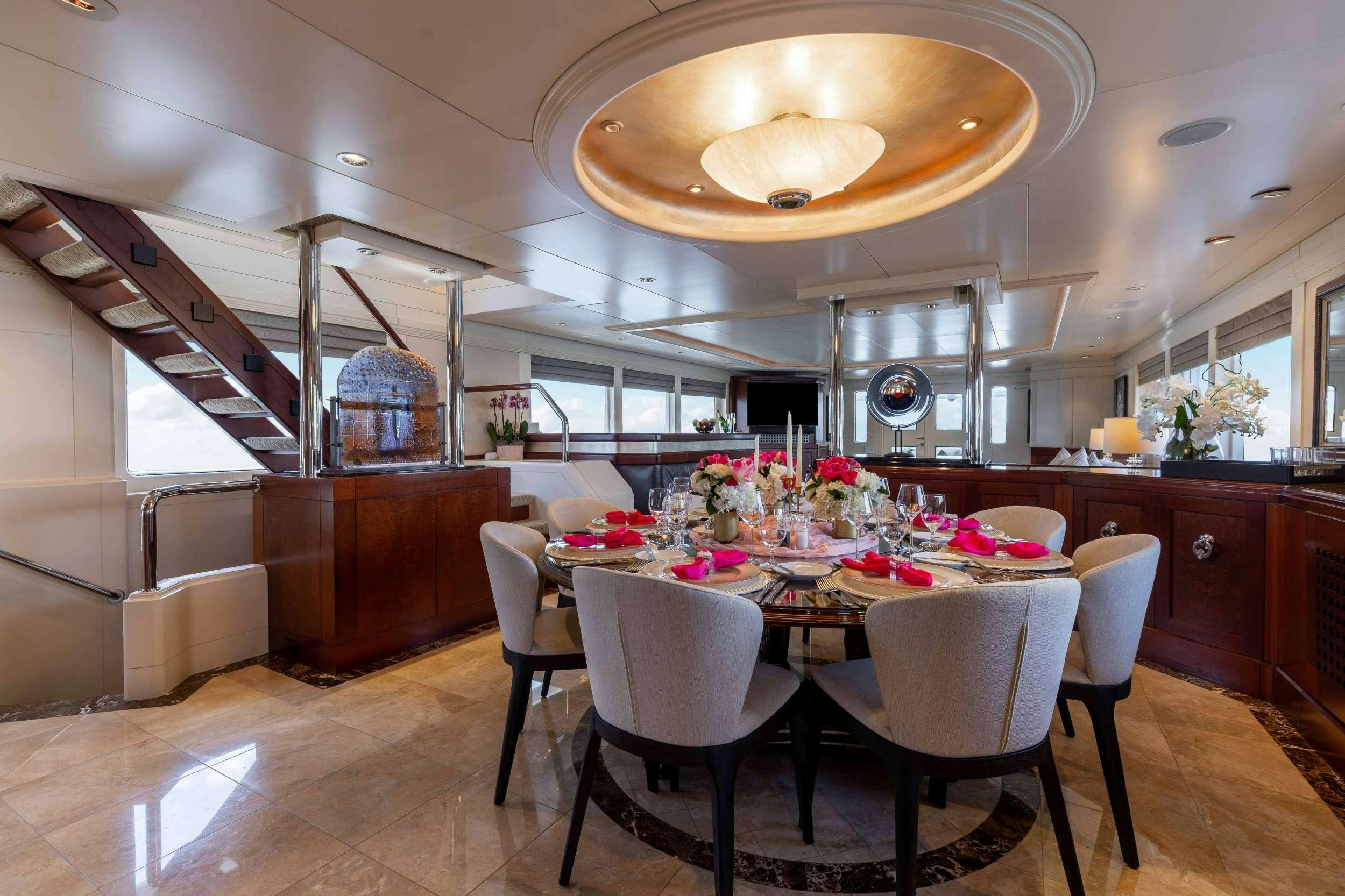 a large kitchen with a dining table aboard LANIDA Yacht for Charter