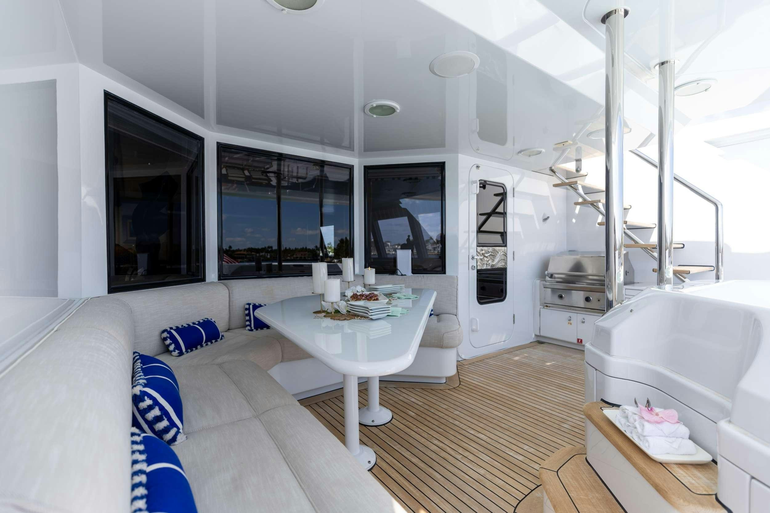a room with a table and a couch aboard LANIDA Yacht for Charter
