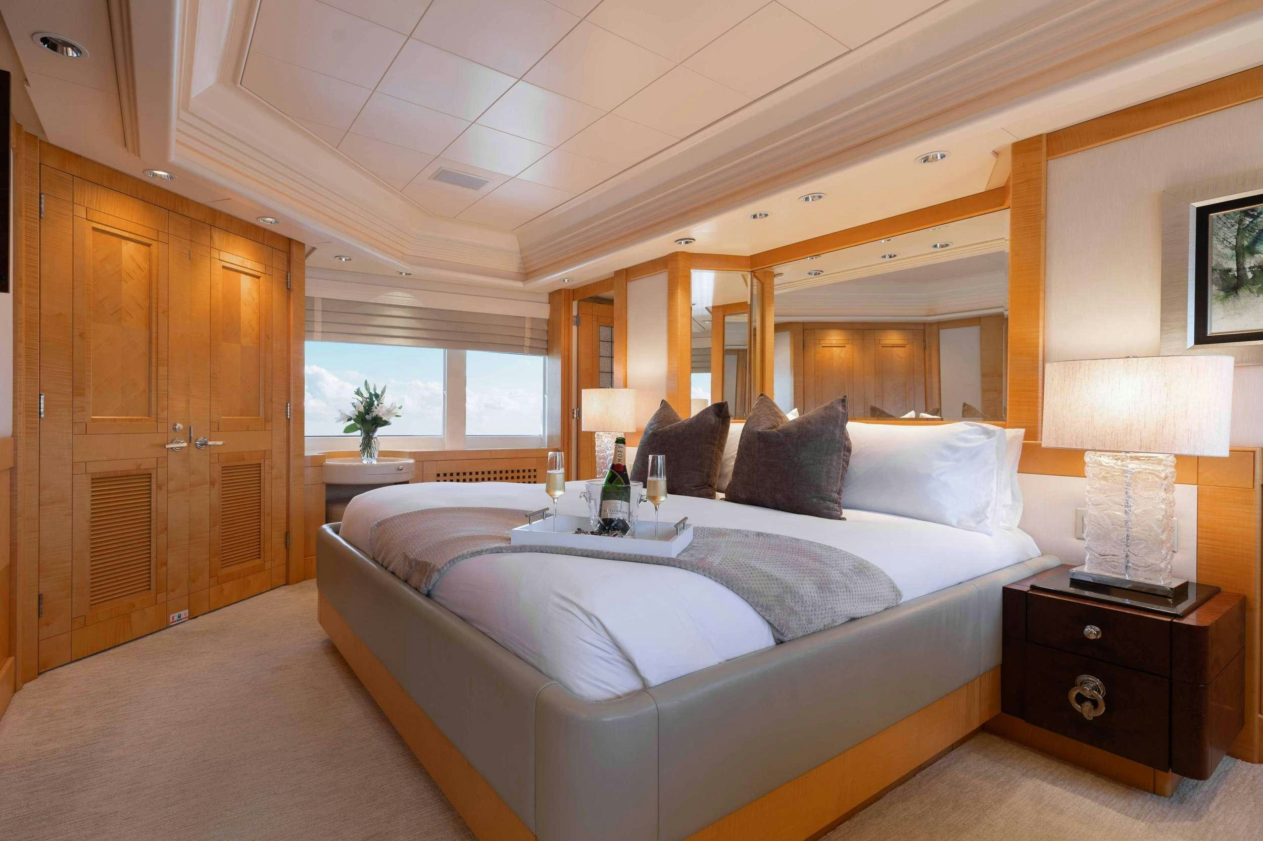 a room with a bed and a wood cabinet aboard LANIDA Yacht for Charter