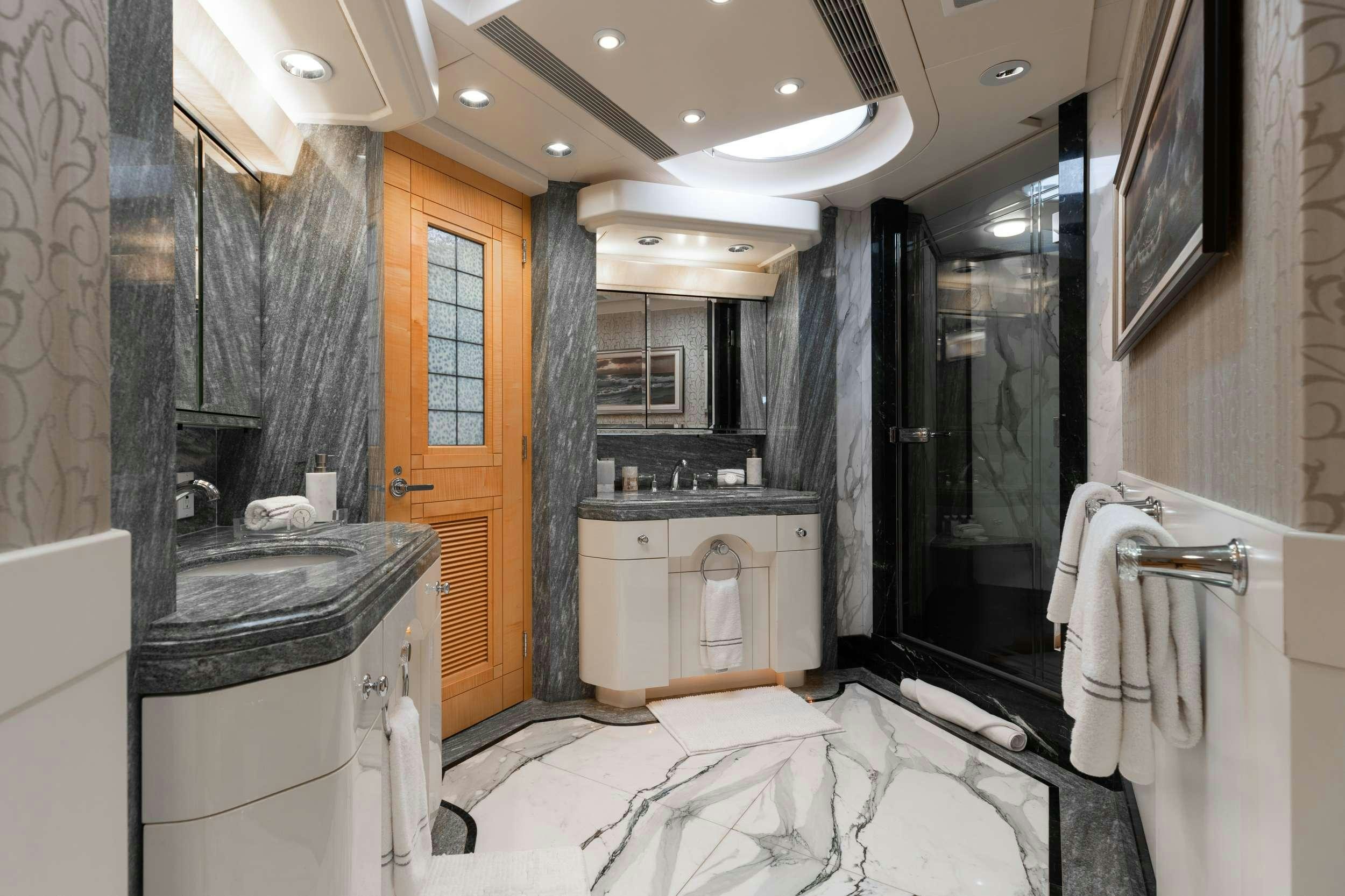 a bathroom with a bathtub and sink aboard LANIDA Yacht for Charter