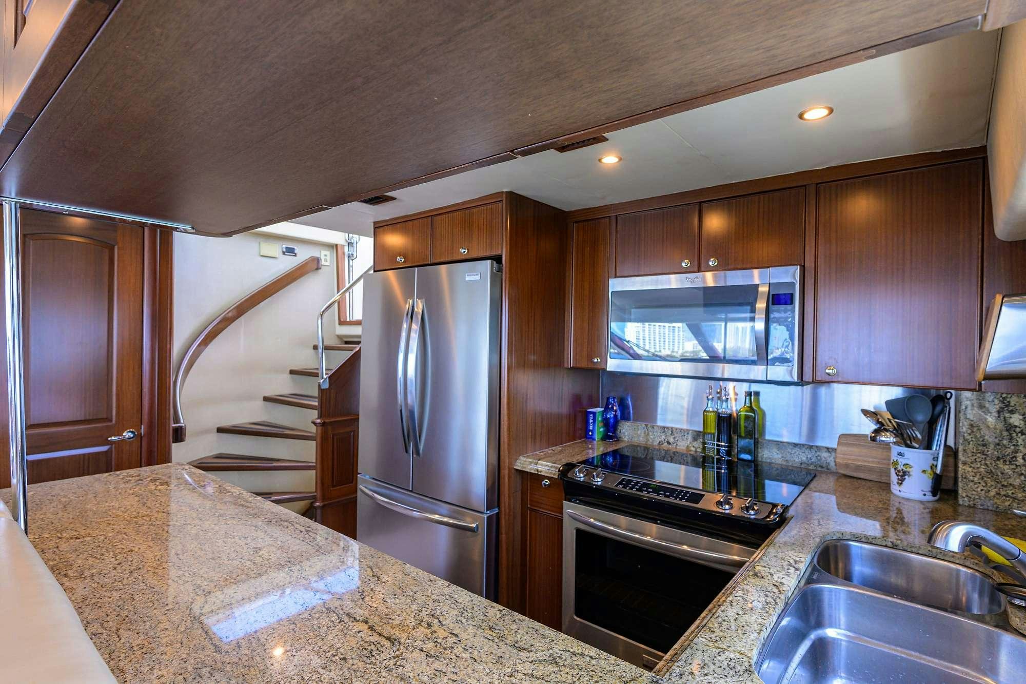 a kitchen with a stainless steel refrigerator aboard JULE Yacht for Charter