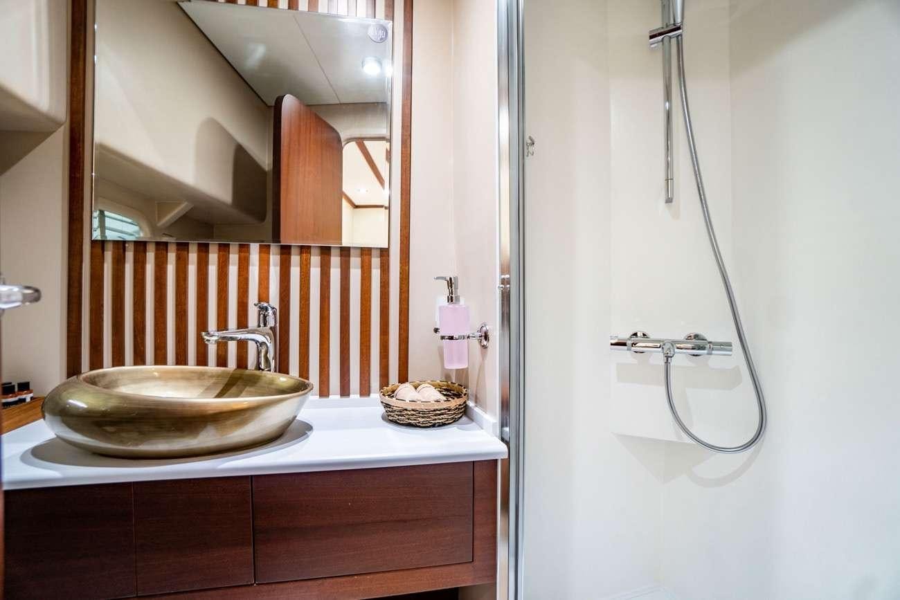 a bathroom with a sink and a mirror aboard LUJA Yacht for Charter