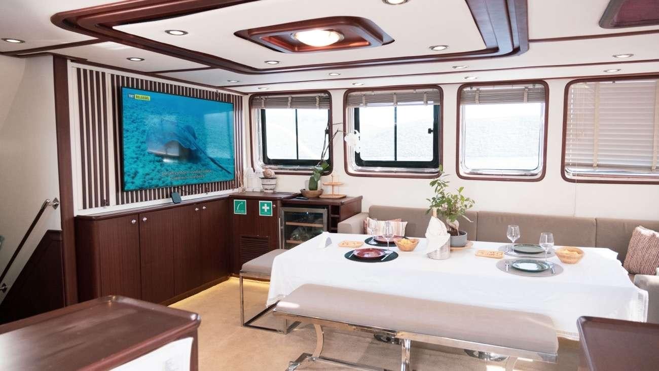 a room with a table and chairs aboard LUJA Yacht for Charter