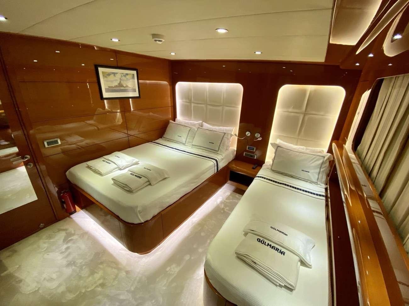 a room with a bed and a chair aboard CANARIA Yacht for Charter