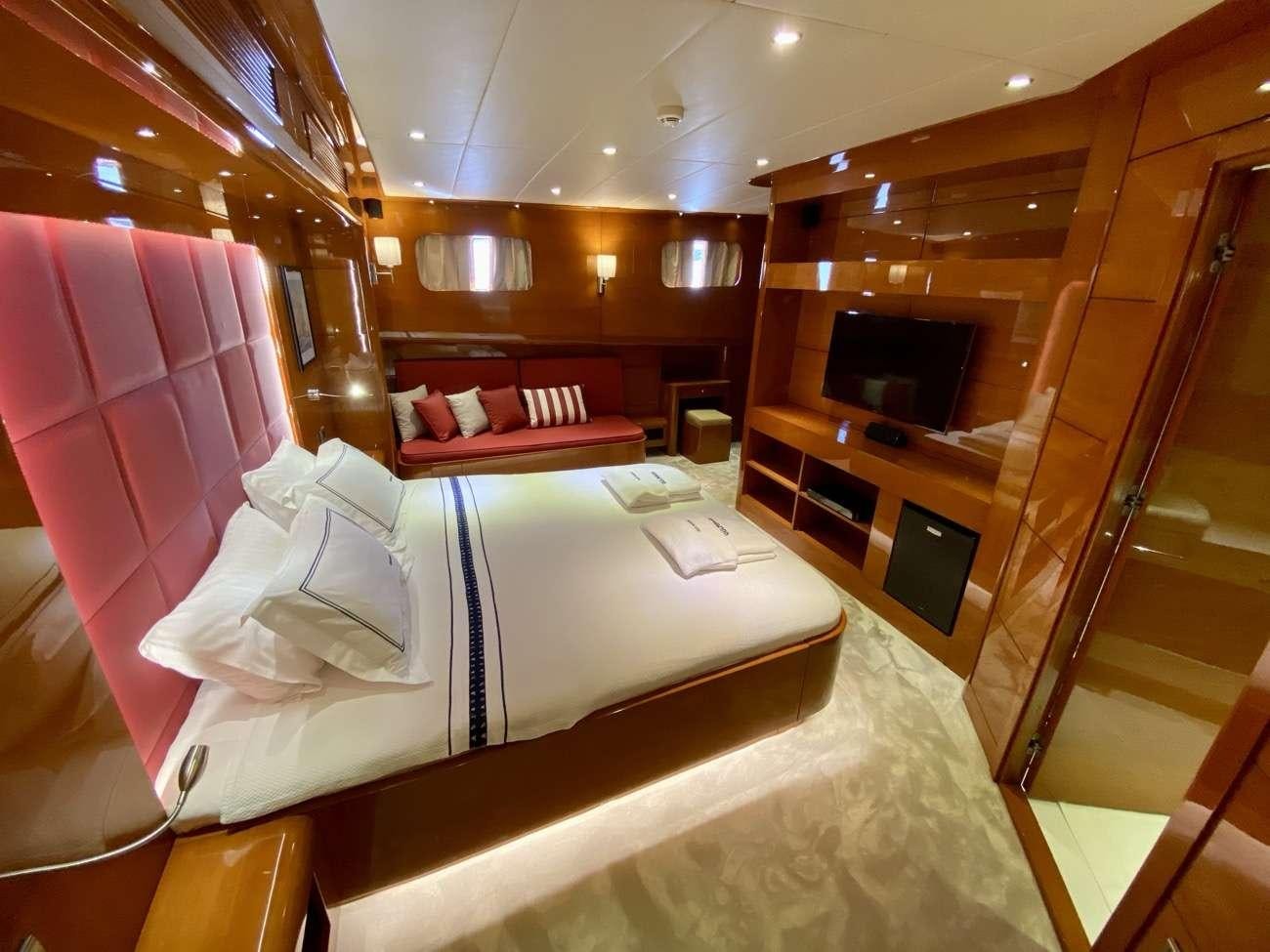 a room with a bed and a fireplace aboard CANARIA Yacht for Charter